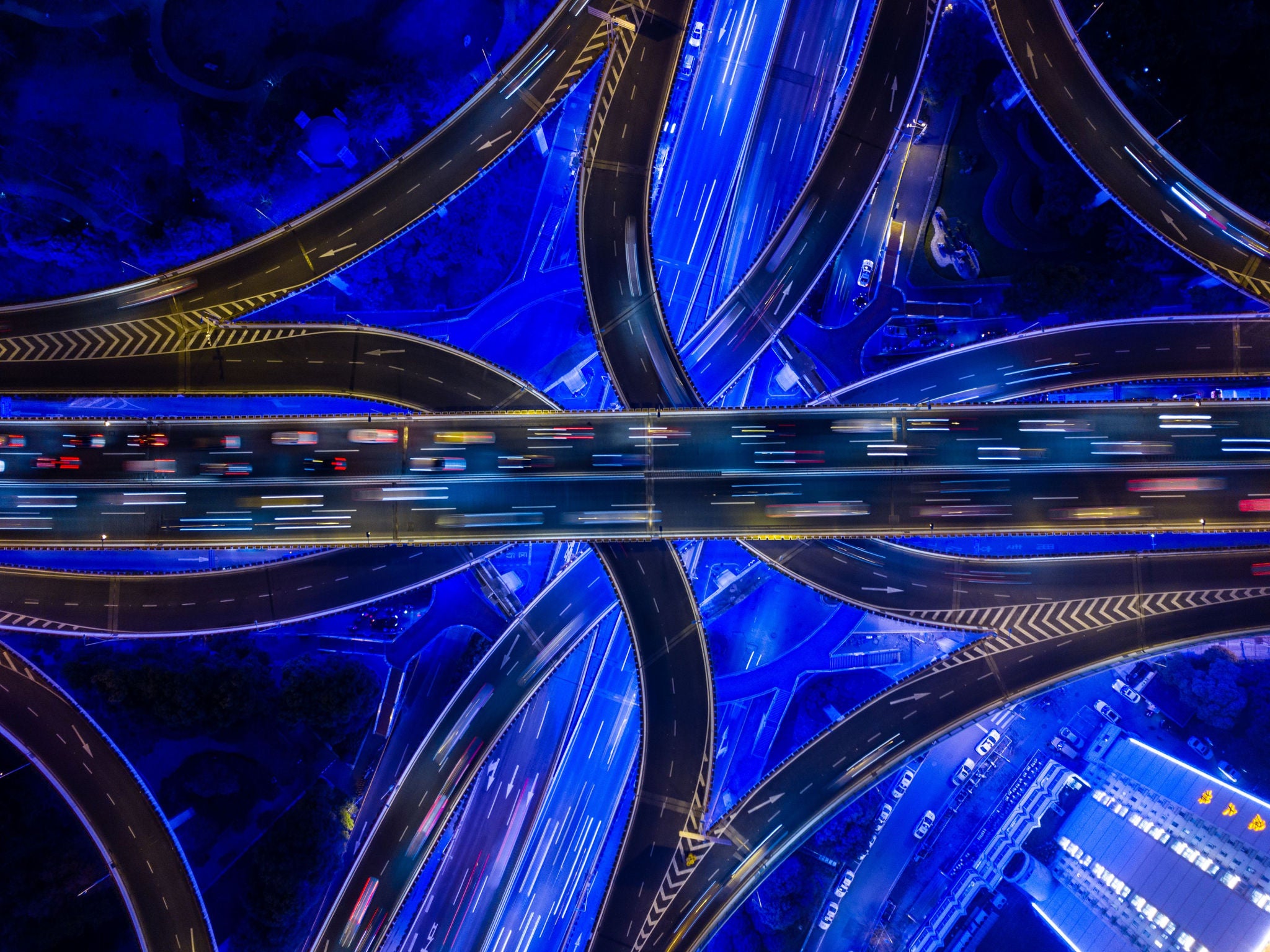 Aerial view of illuminated highway interchange at night.