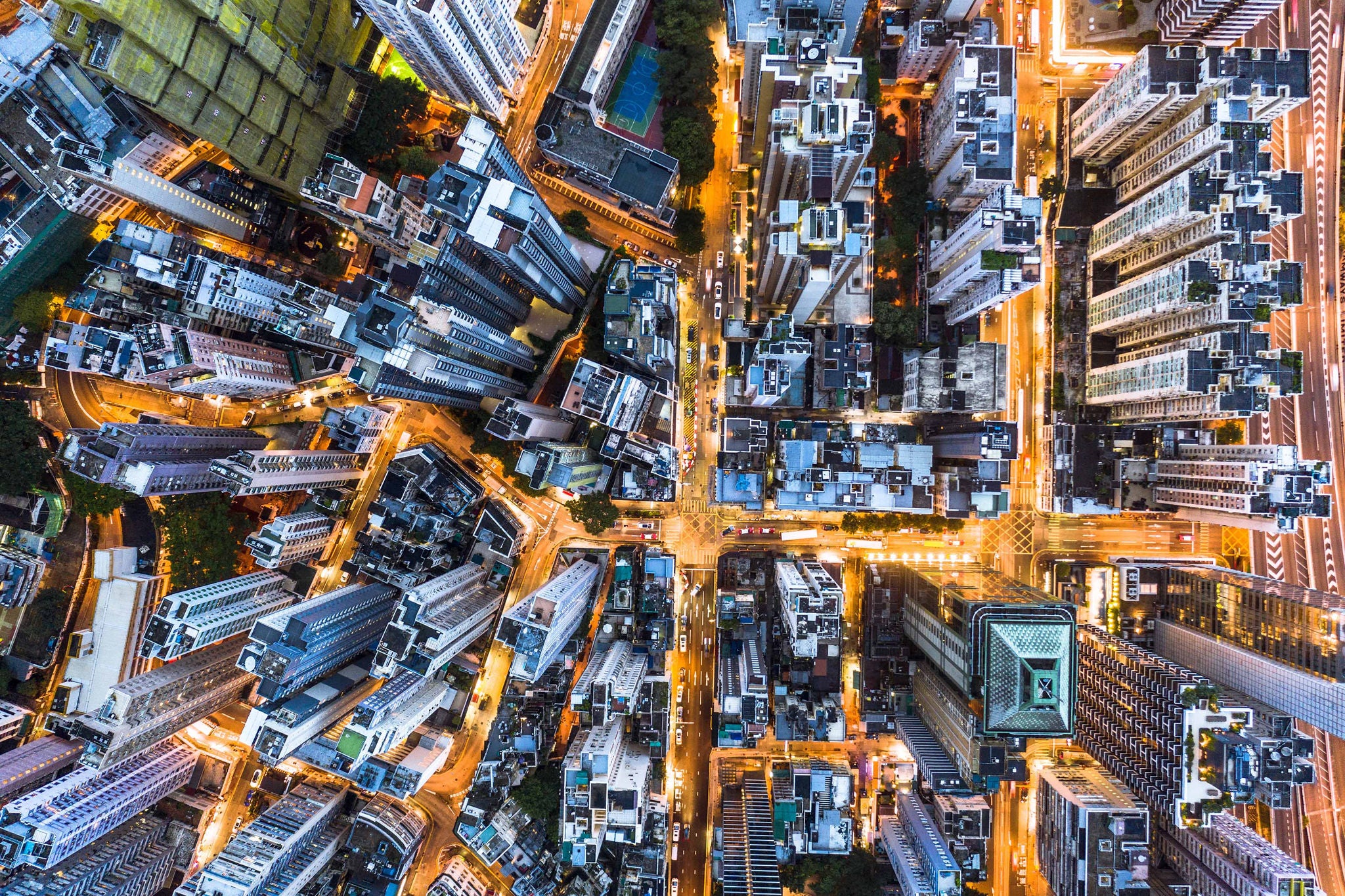 Aerial view of busy Hong Kong streets at night, full of lights and traffic