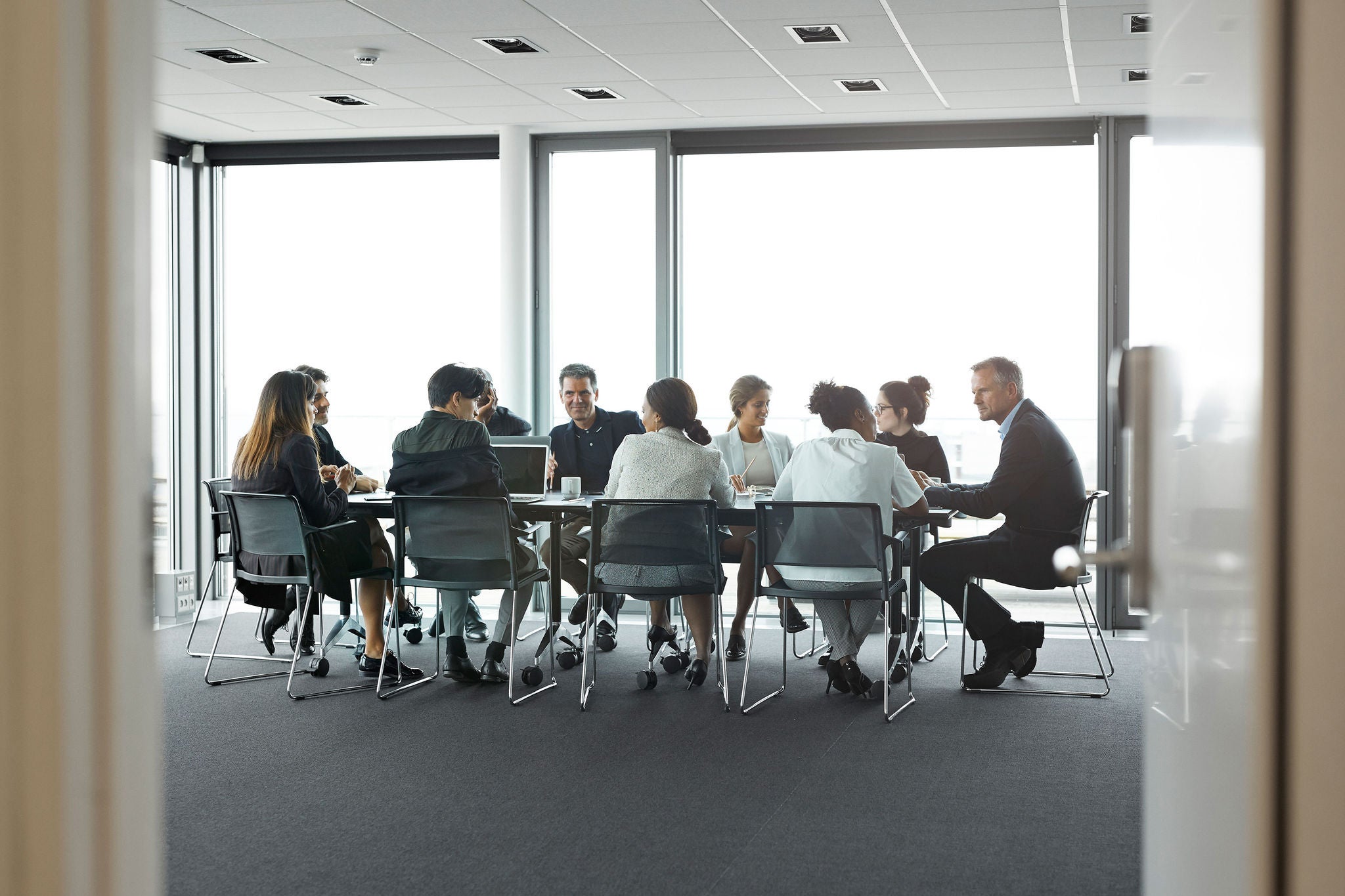 Business people in large modern meeting room