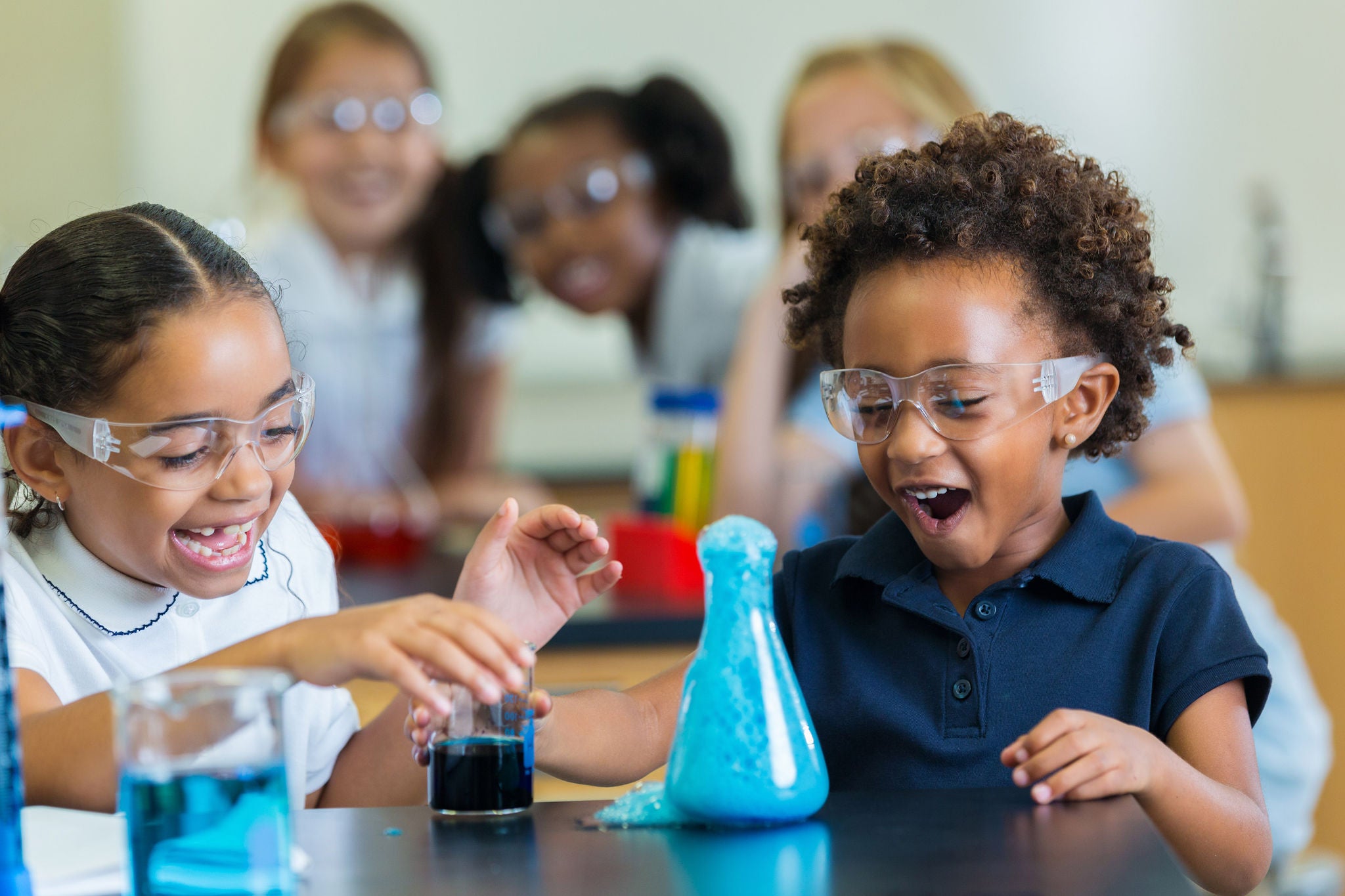 EY - Excited school girls during chemistry experiment