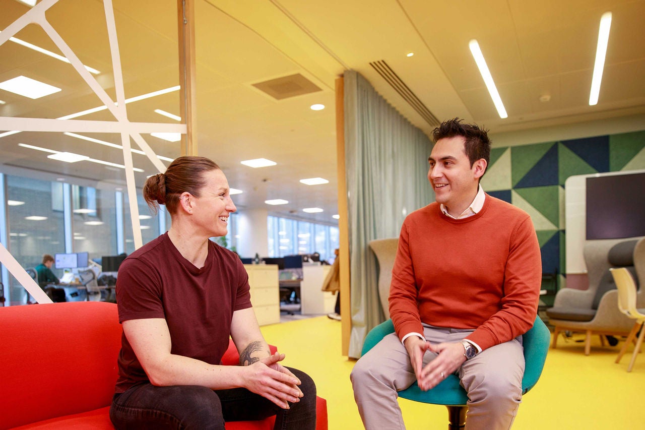 Two people sitting down and talking