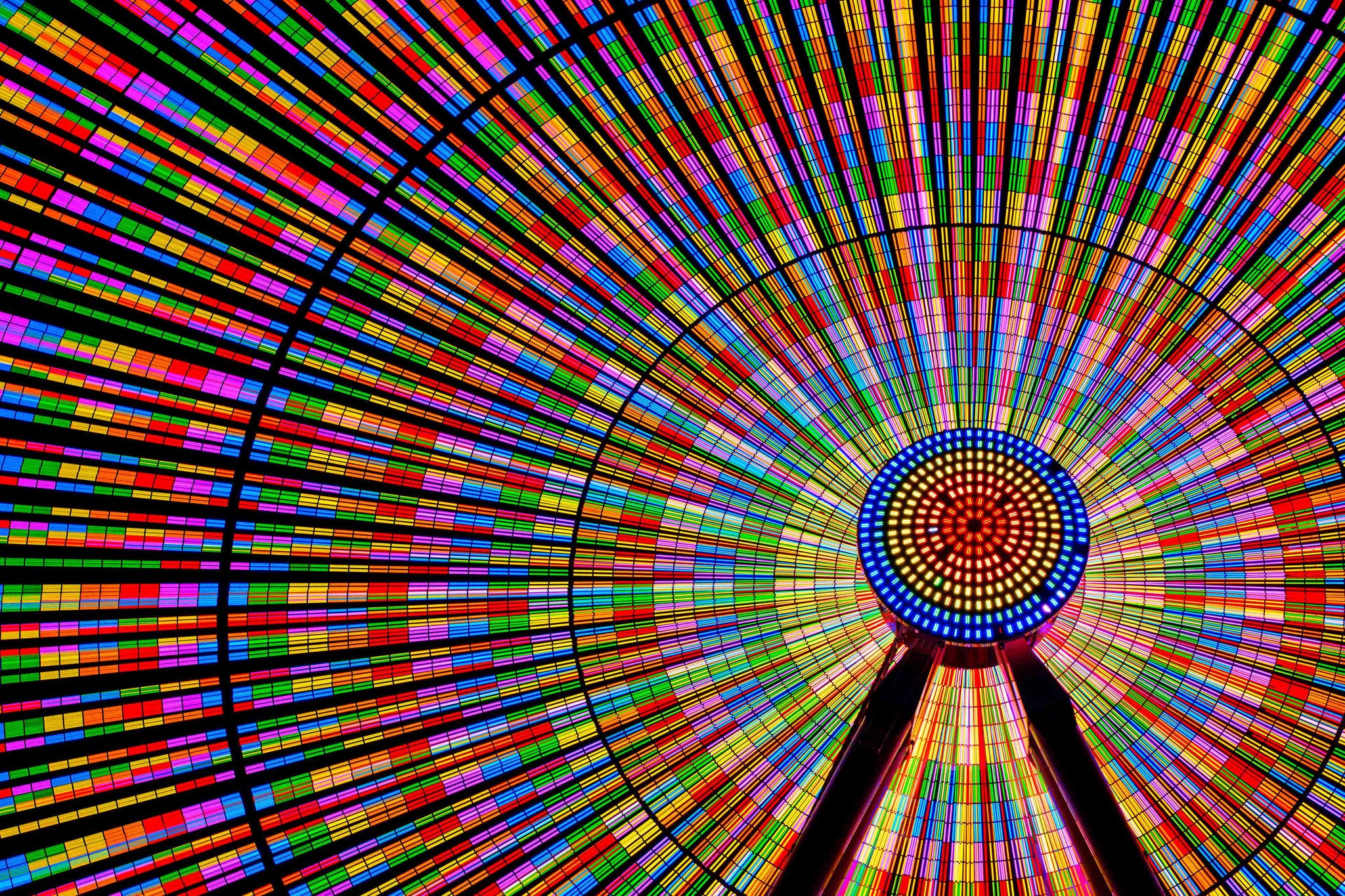 Vibrant circular light display with multicolor patterns creating abstract visual energy