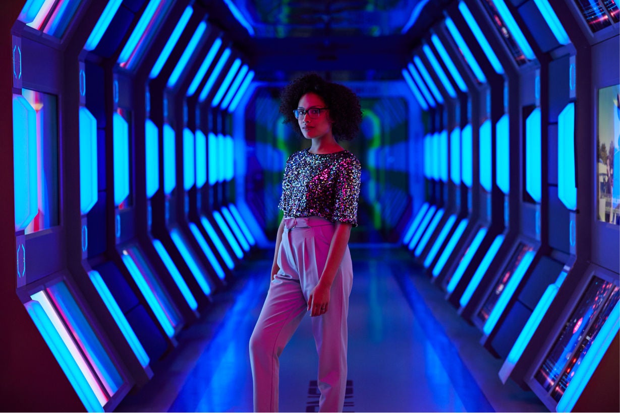 Portrait of young businesswoman looking in camera in spaceship like corridor