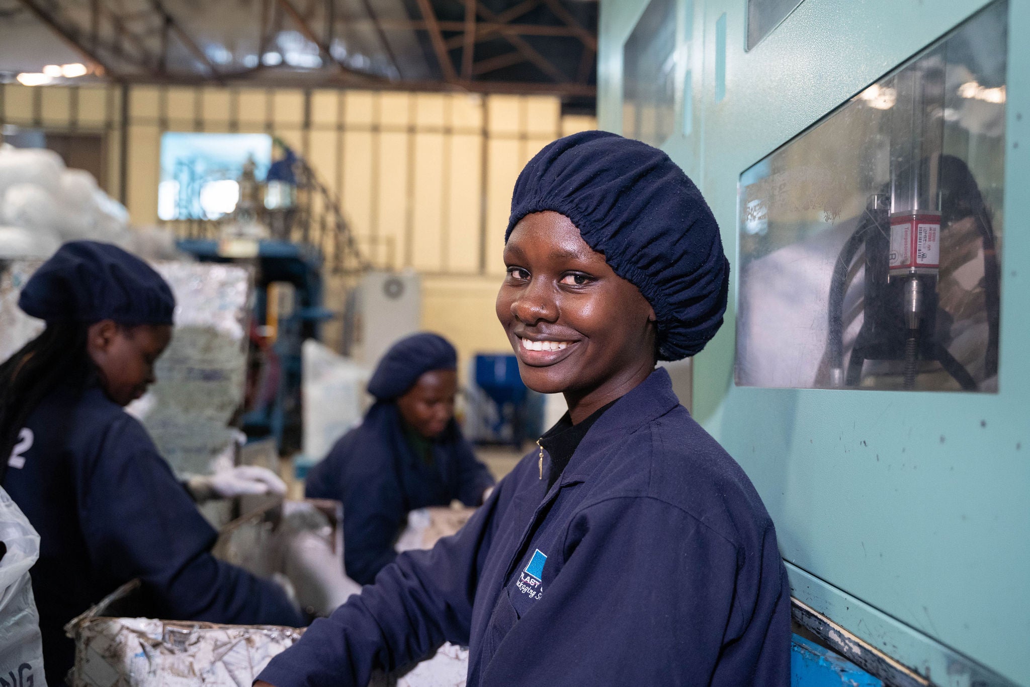 Clarice Bala Adhiambo stops packaging bottles made from recycled plastic to pose for a photograph at a recycling factory in Nairobi. Taka Taka ni Mali is a leading not-for-profit organisation working to strengthen connections in the waste management ecosystem in Kenya, turning it into a circular economy.