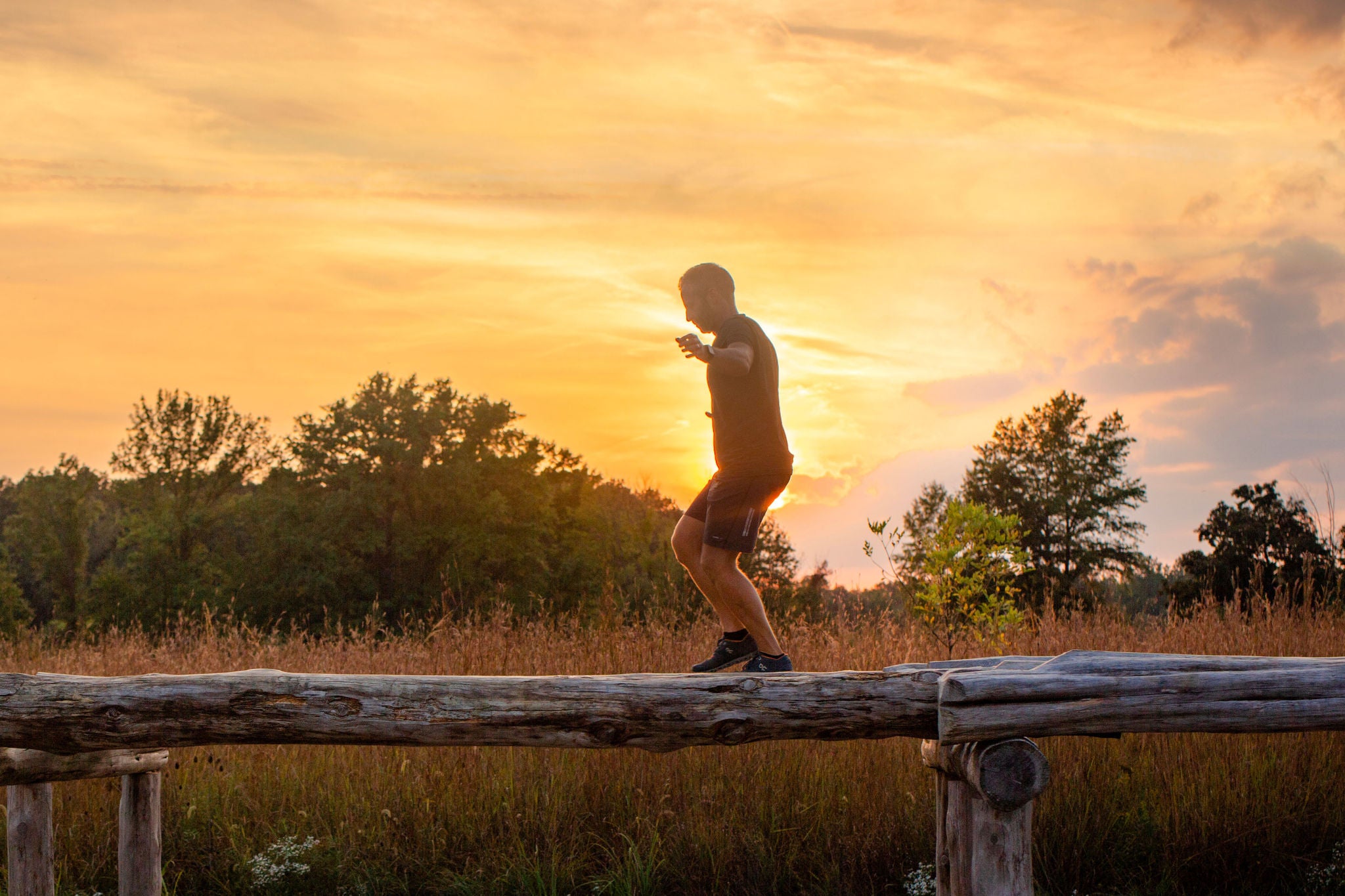 Man working on laptop while sitting in kitchen at home
