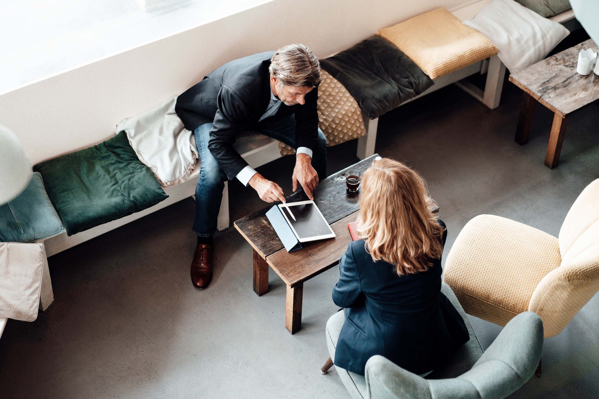 Rear view of woman sitting on sofa