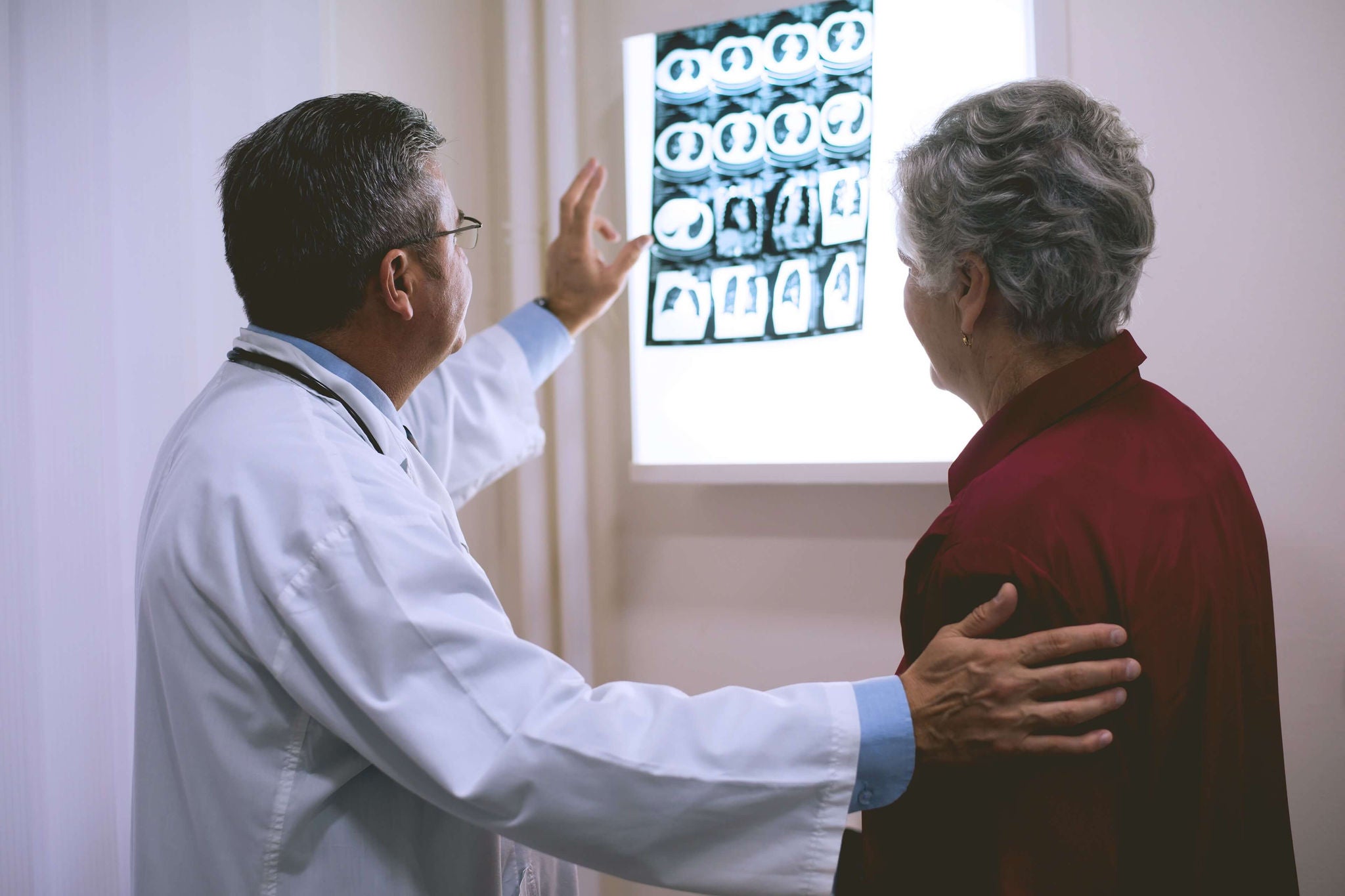 Doctor looking  scan patient