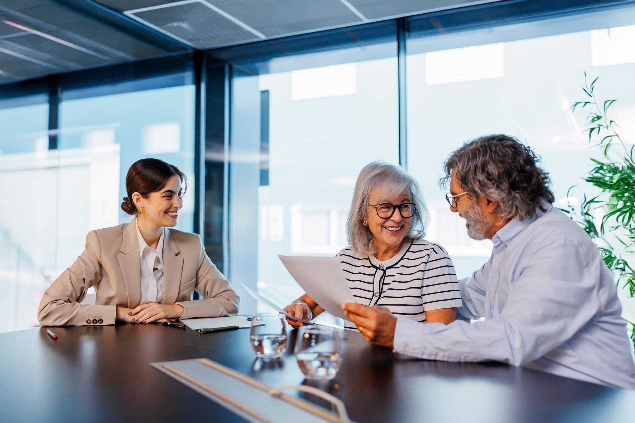 Senior couple reviewing documents with financial advisor