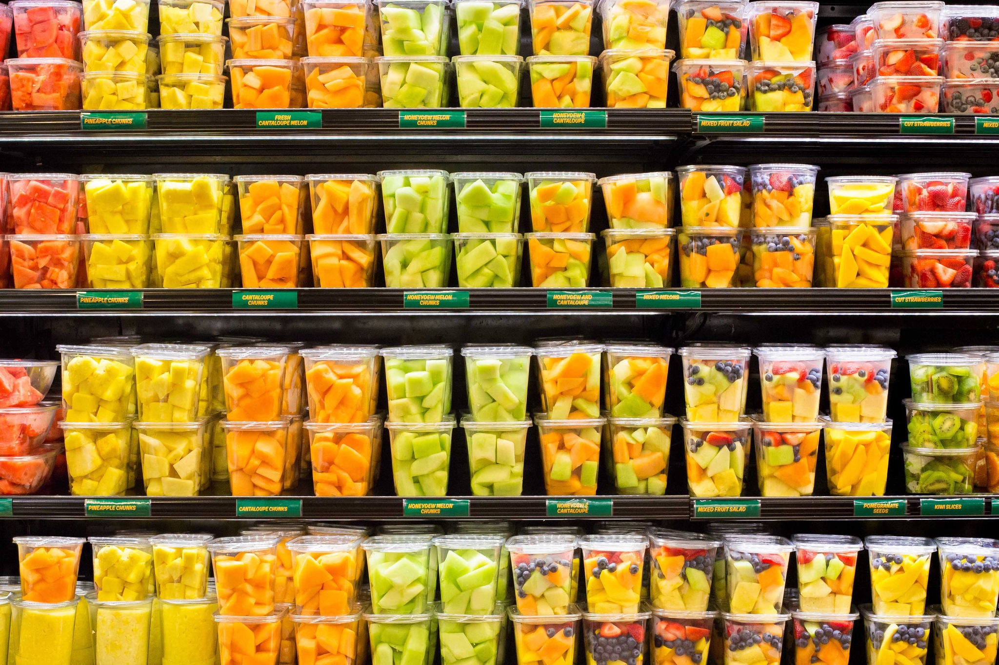 Assortment of fresh cut fruit in plastic containers