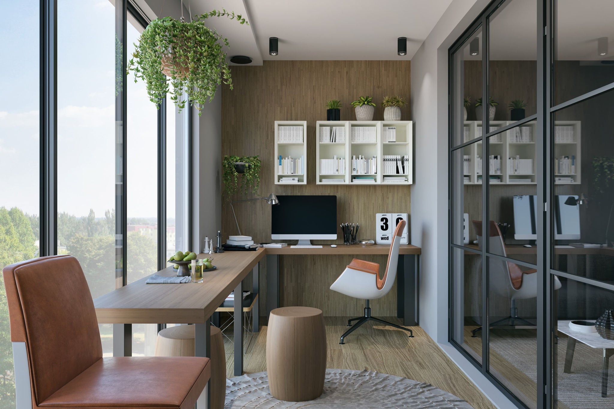 Heller Arbeitsbereich mit Schreibtisch, Computer und natürlicher Begrünung.