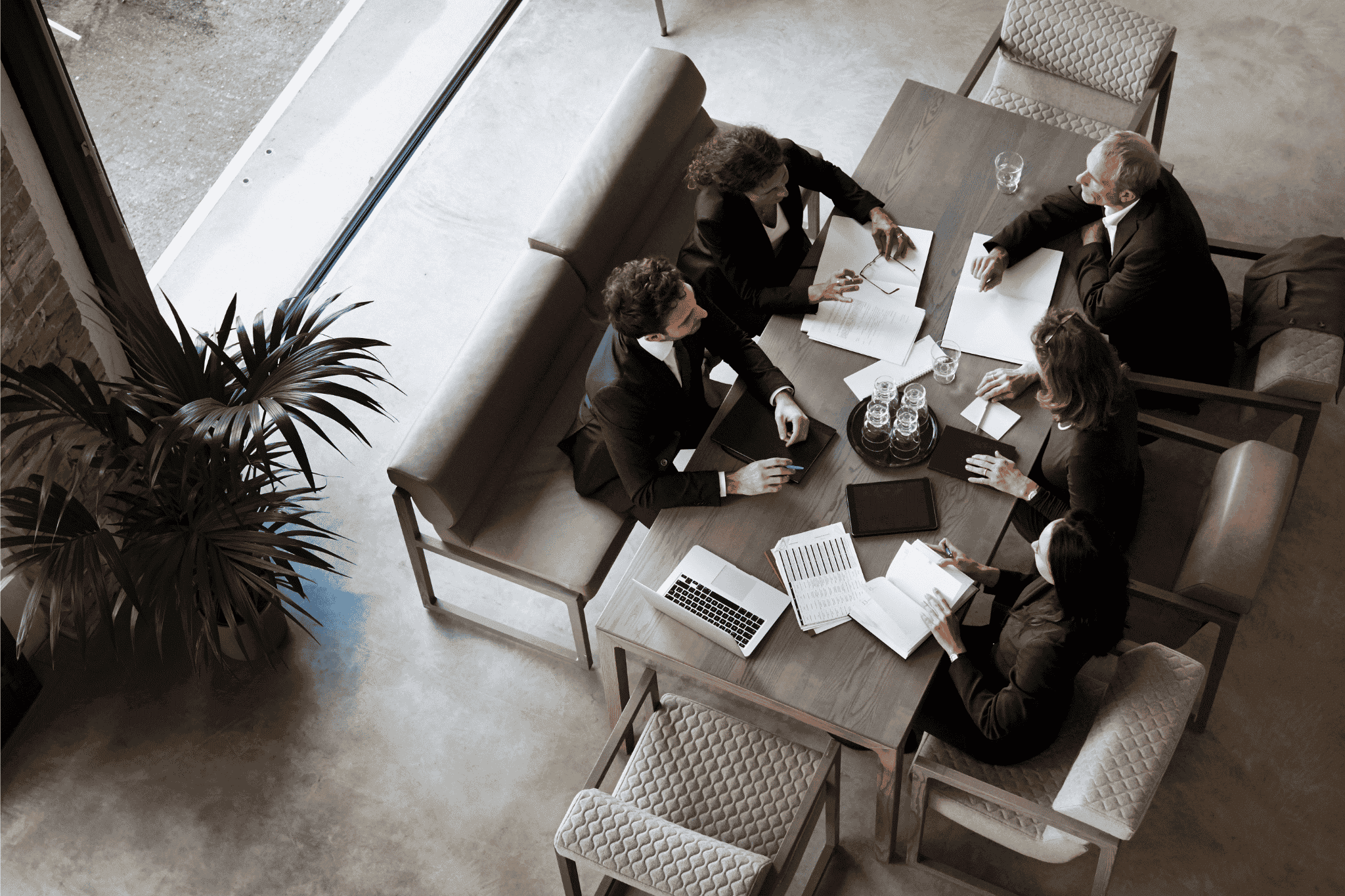 This image features business colleagues having a meeting in a lobby,