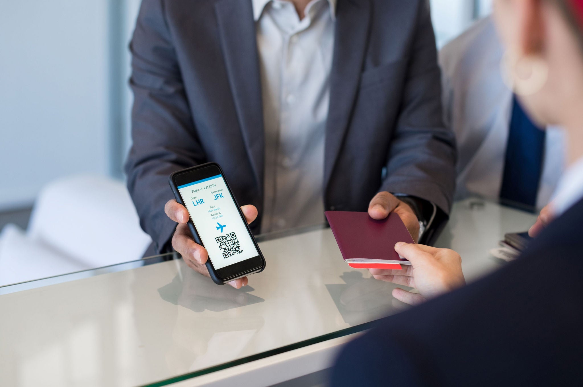 Man showing his flight ticket at the counter.