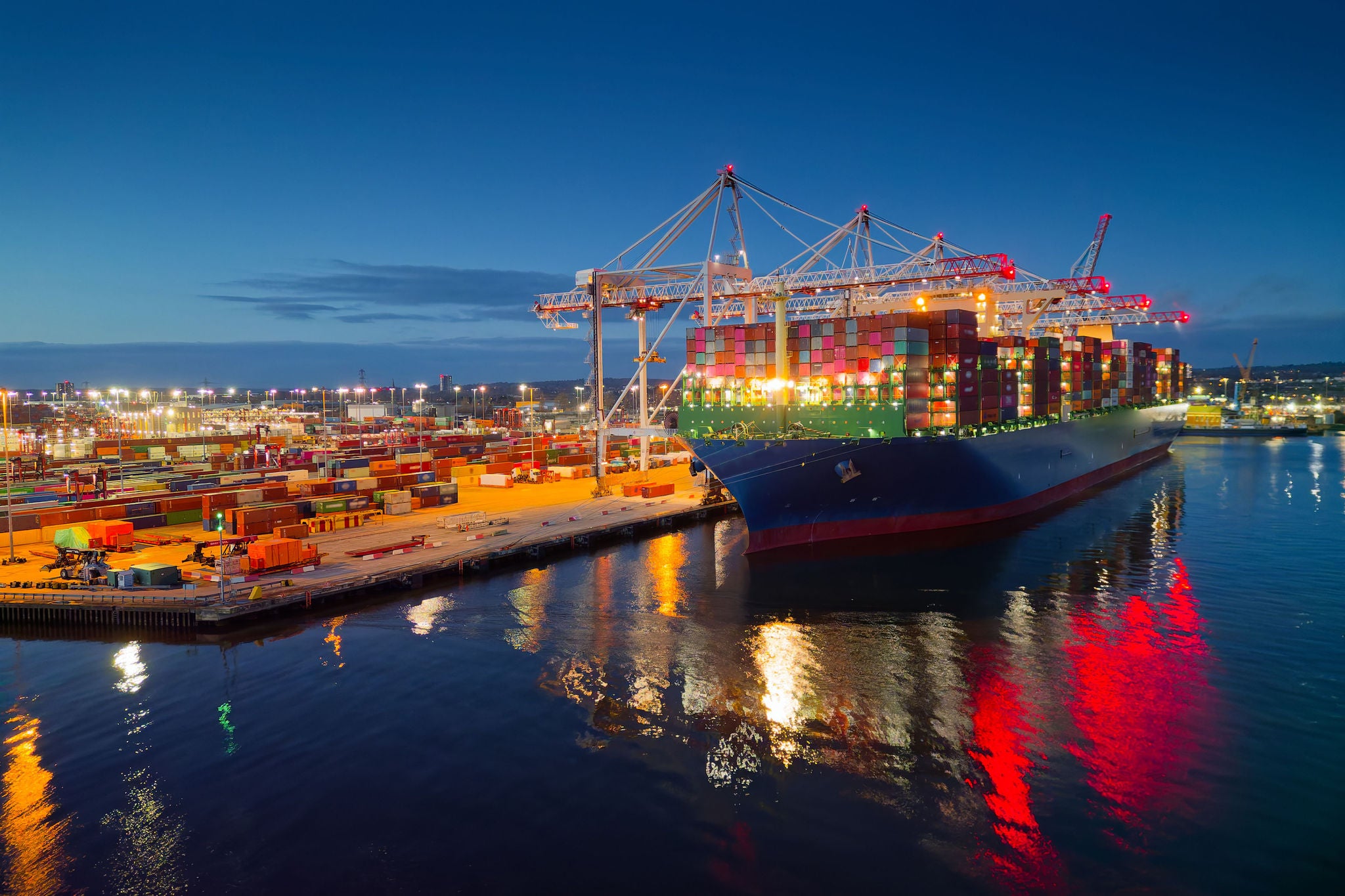 Beautiful light reflection on calm sea and dark blue sky. Place of work in shipping industry.