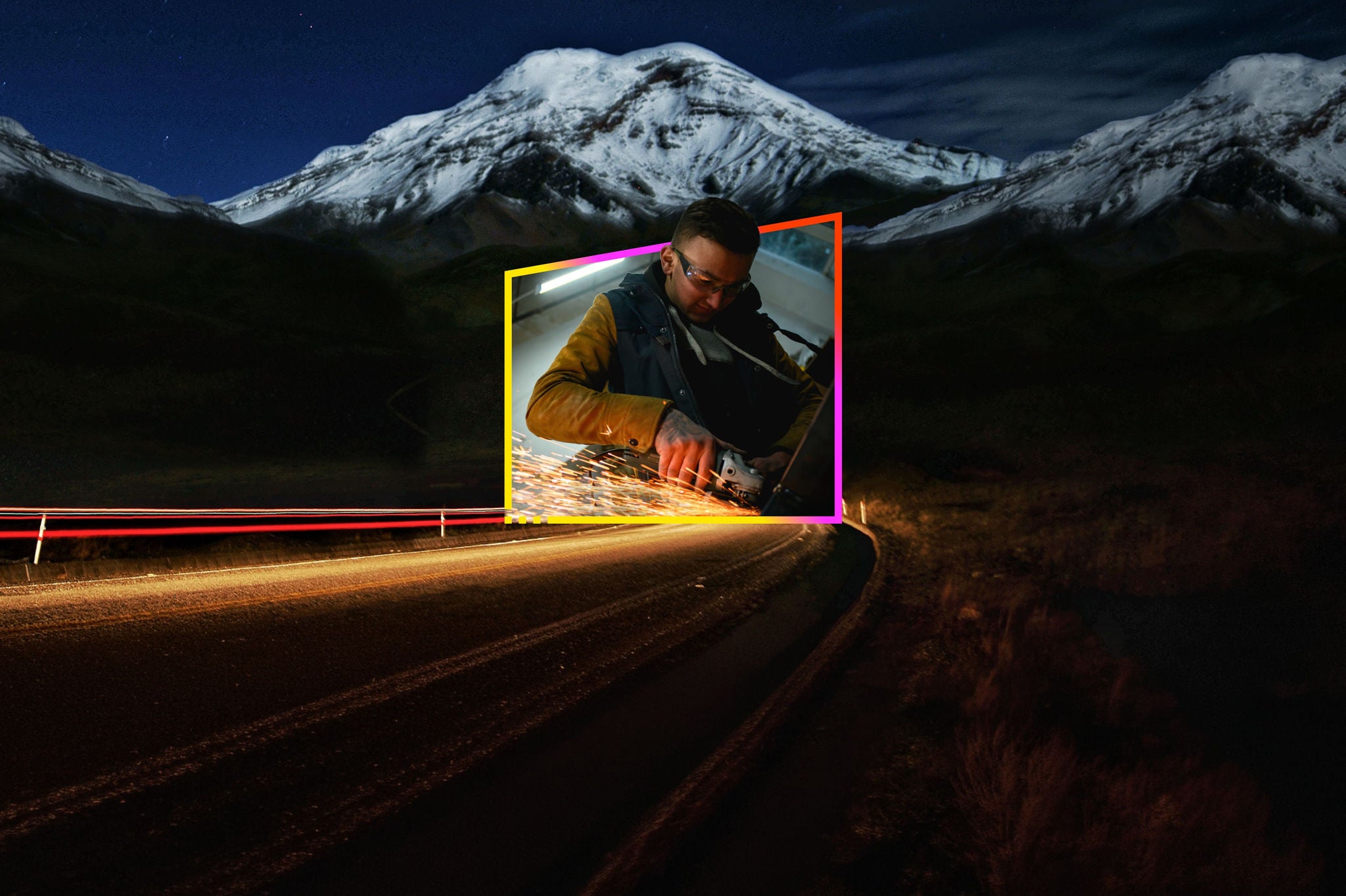 Worker grinding metal with sparks against a nighttime mountain road backdrop
