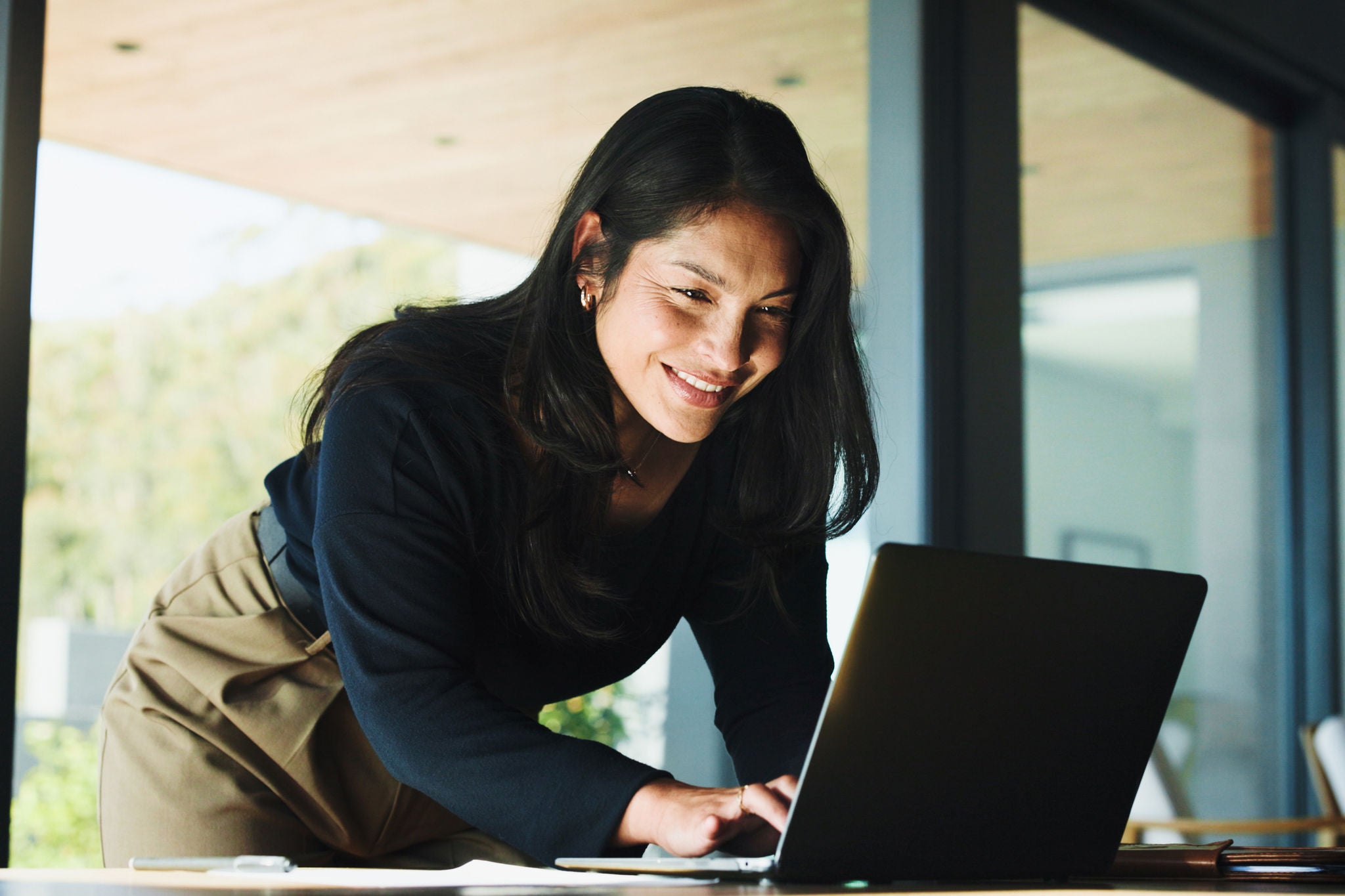 Laptop, typing and research with business woman in office for real estate broker, property listing and planning. Escrow account closer, realtor proposal and project with person in agency for report.