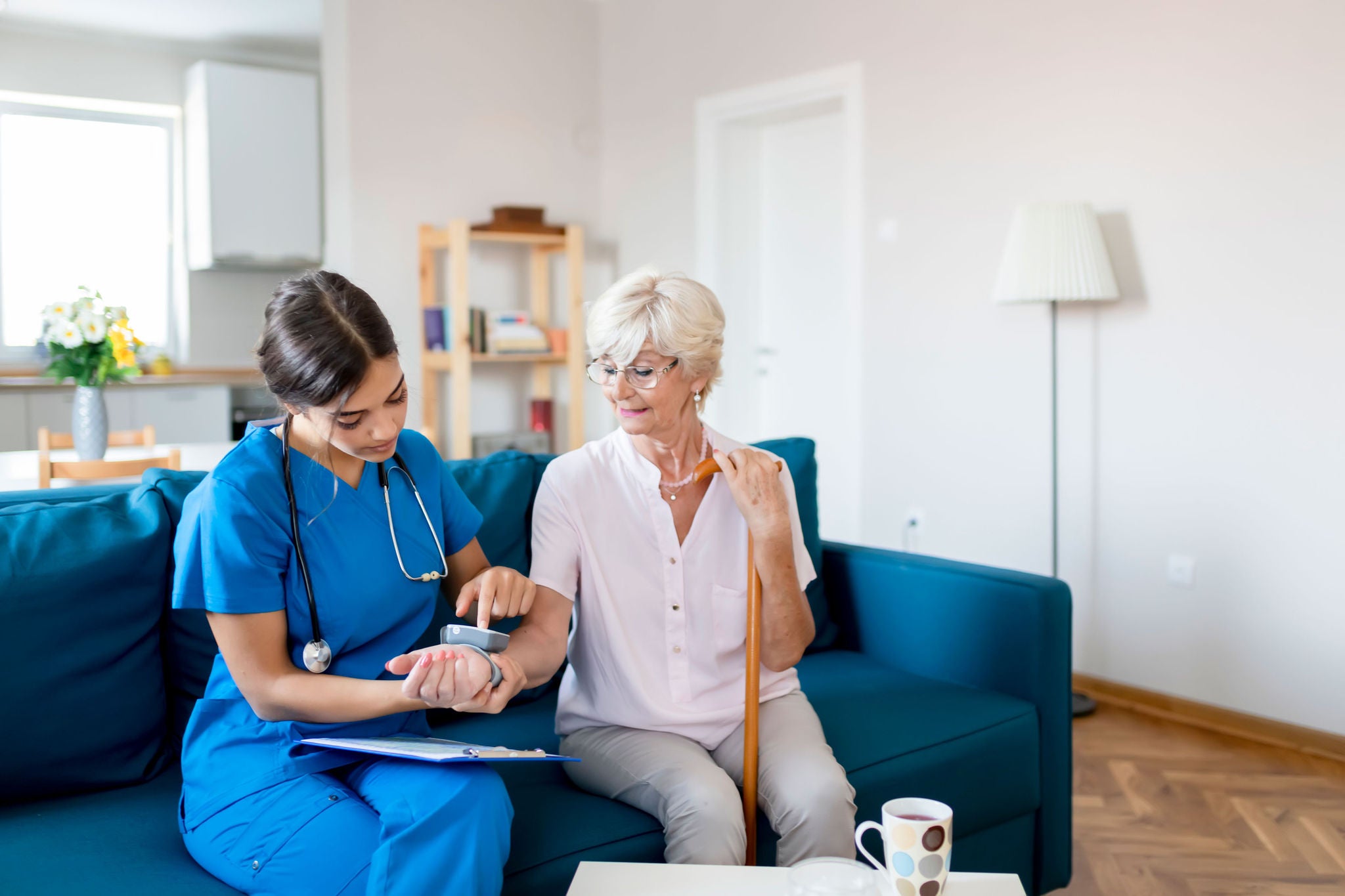 Female nurse measuring blood pressure
