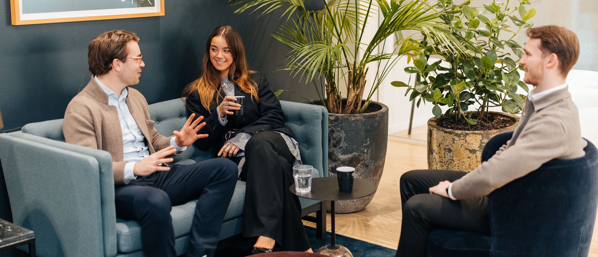 Professionals discussing ideas in informal office collaboration space