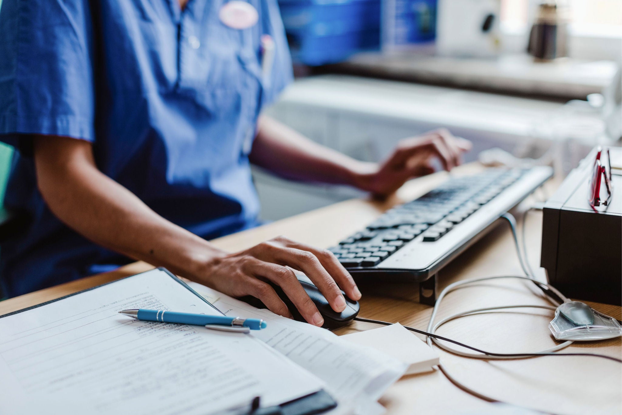 nurse-using-computer-at-desk-in-hospital