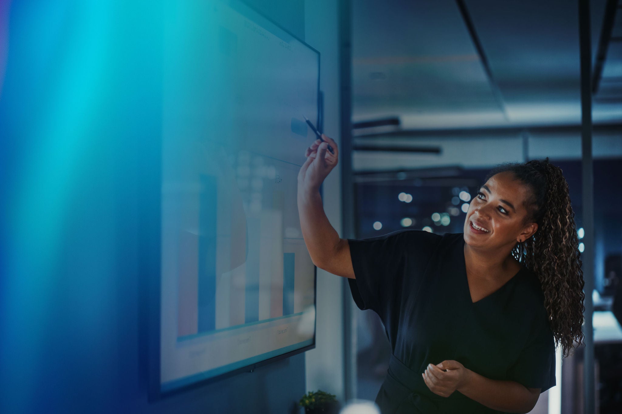 Professional presenting data charts on screen during meeting
