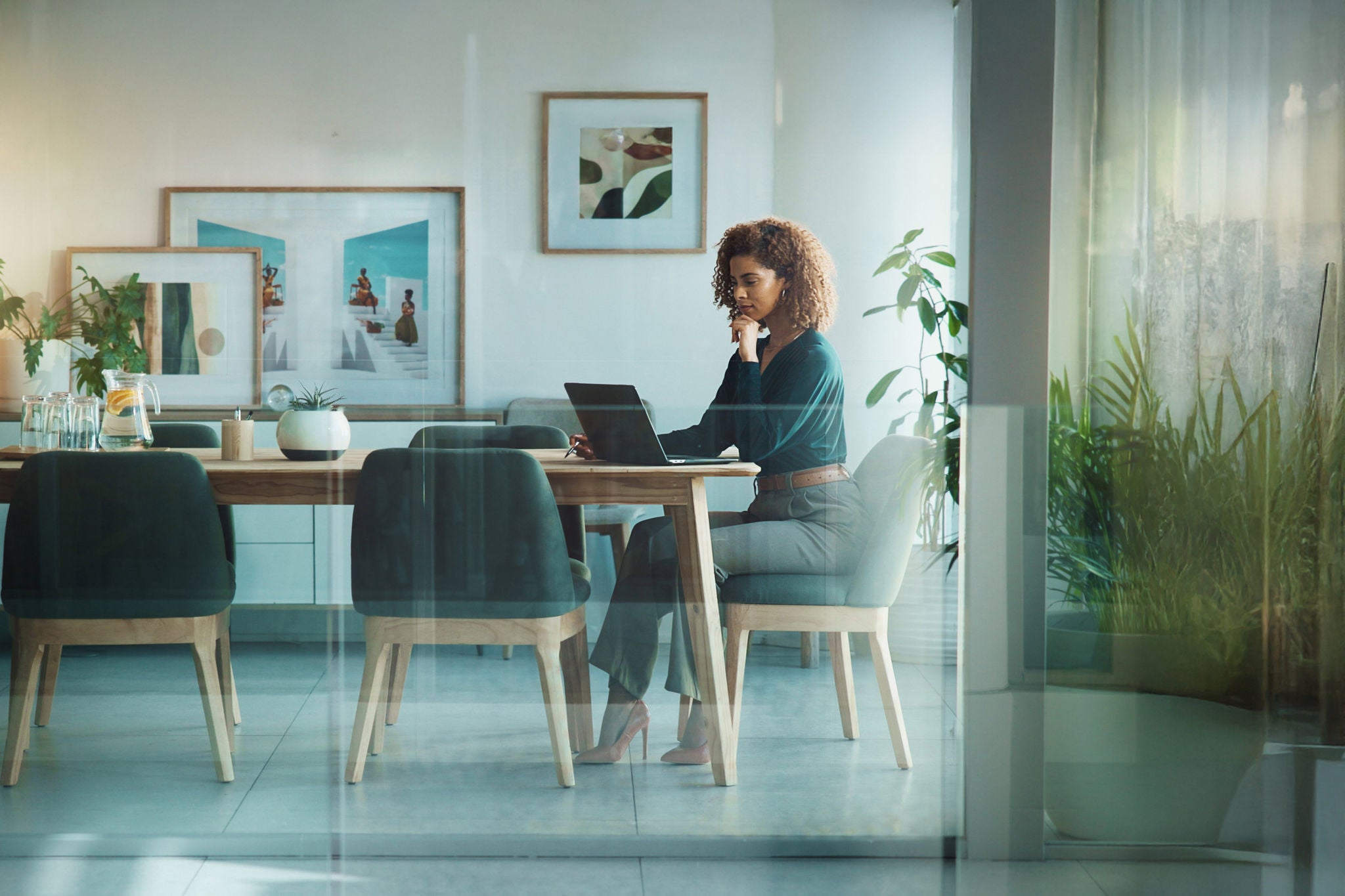 Laptop, ideas and businesswoman in office for project proposal at creative startup company. Thinking, decision and female copywriter with computer for multimedia journalism in boardroom at workplace