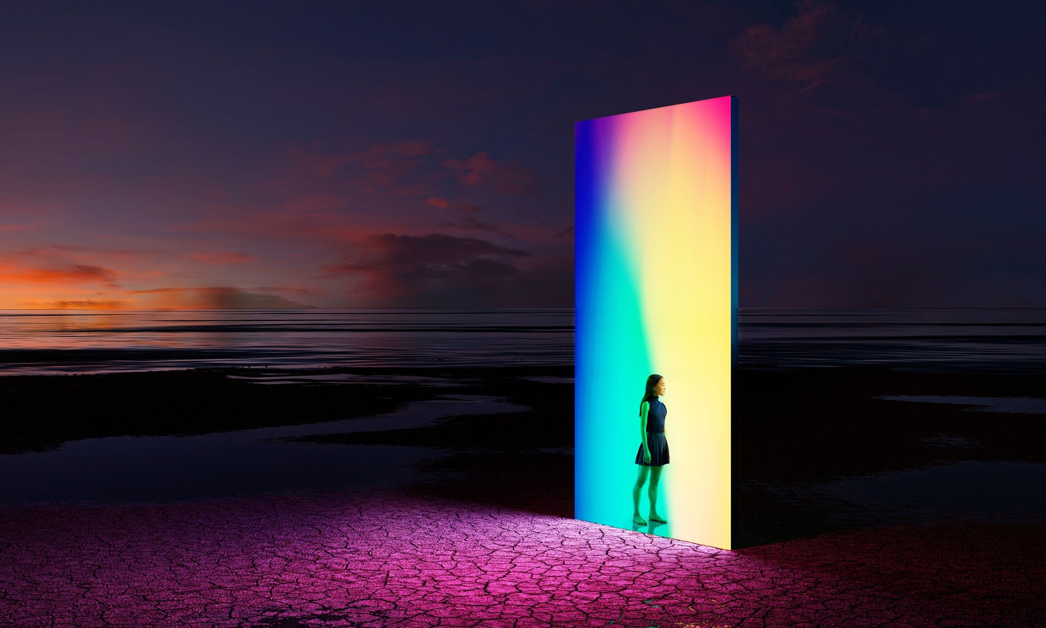 Digital generated image of young woman standing on entrance of  multicoloured portal door. Metaverse concept.
