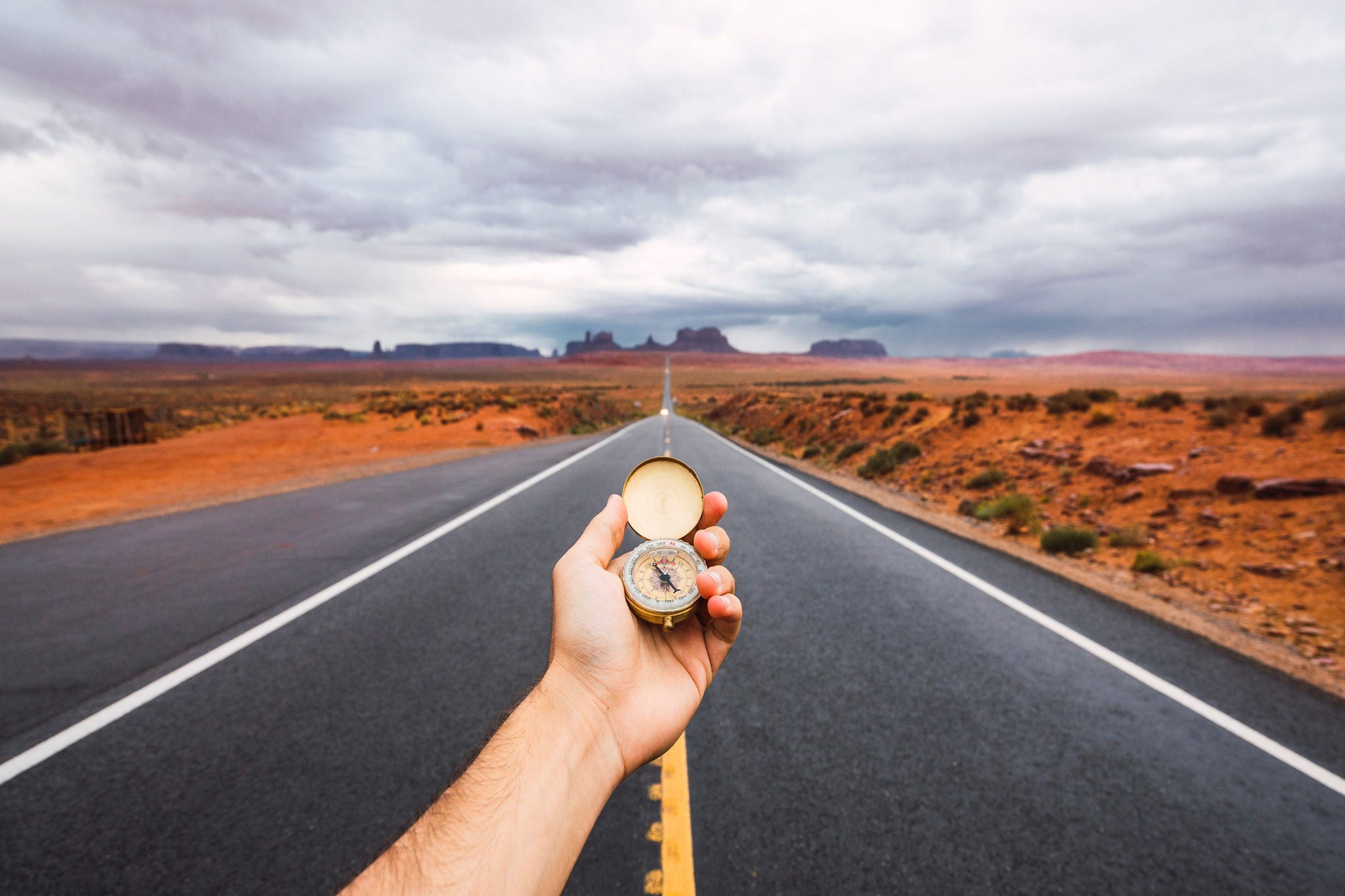 Hand with compas on the road