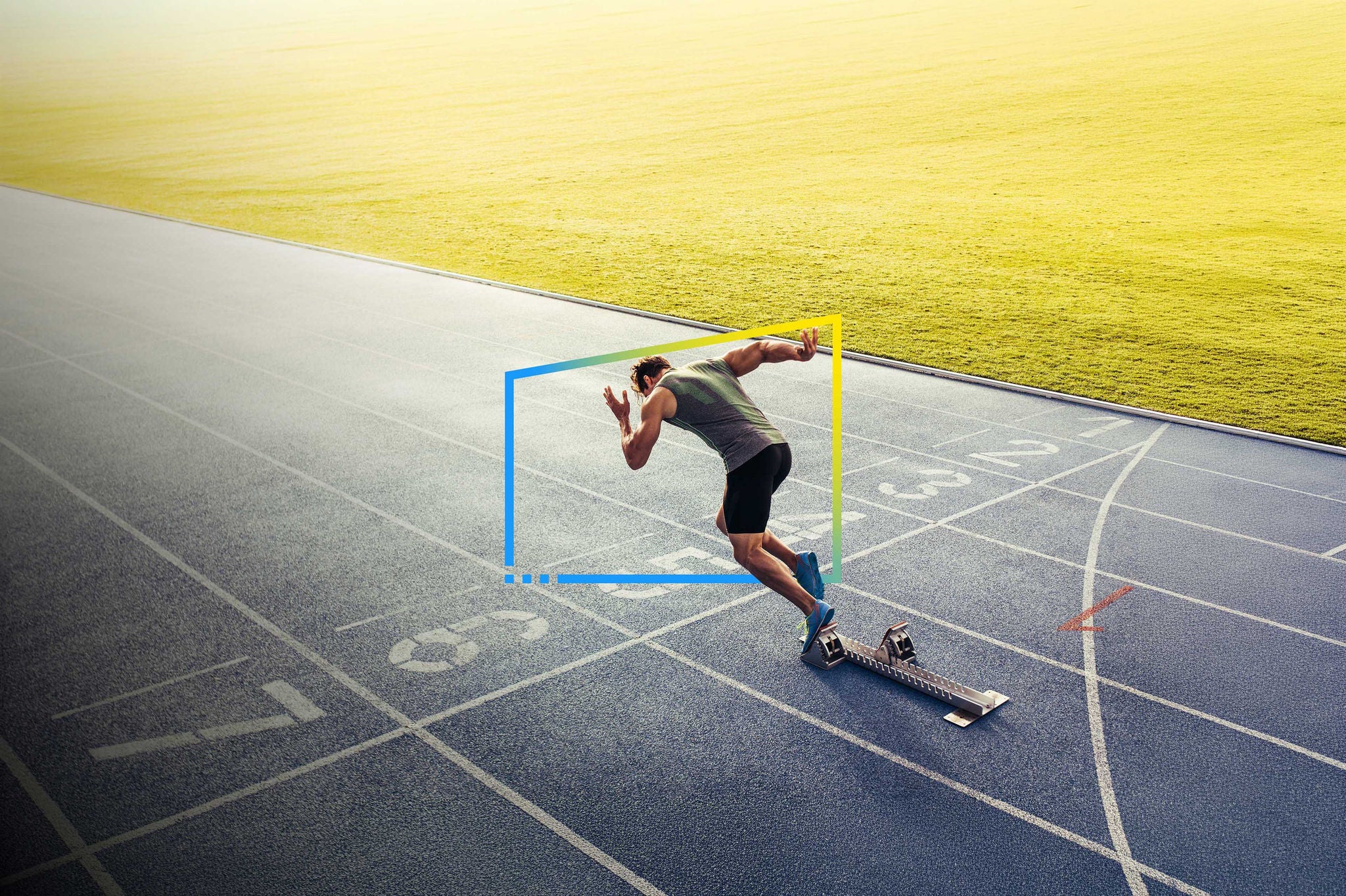 Runner starts sprint from blocks on track, representing speed, precision and forward momentum.