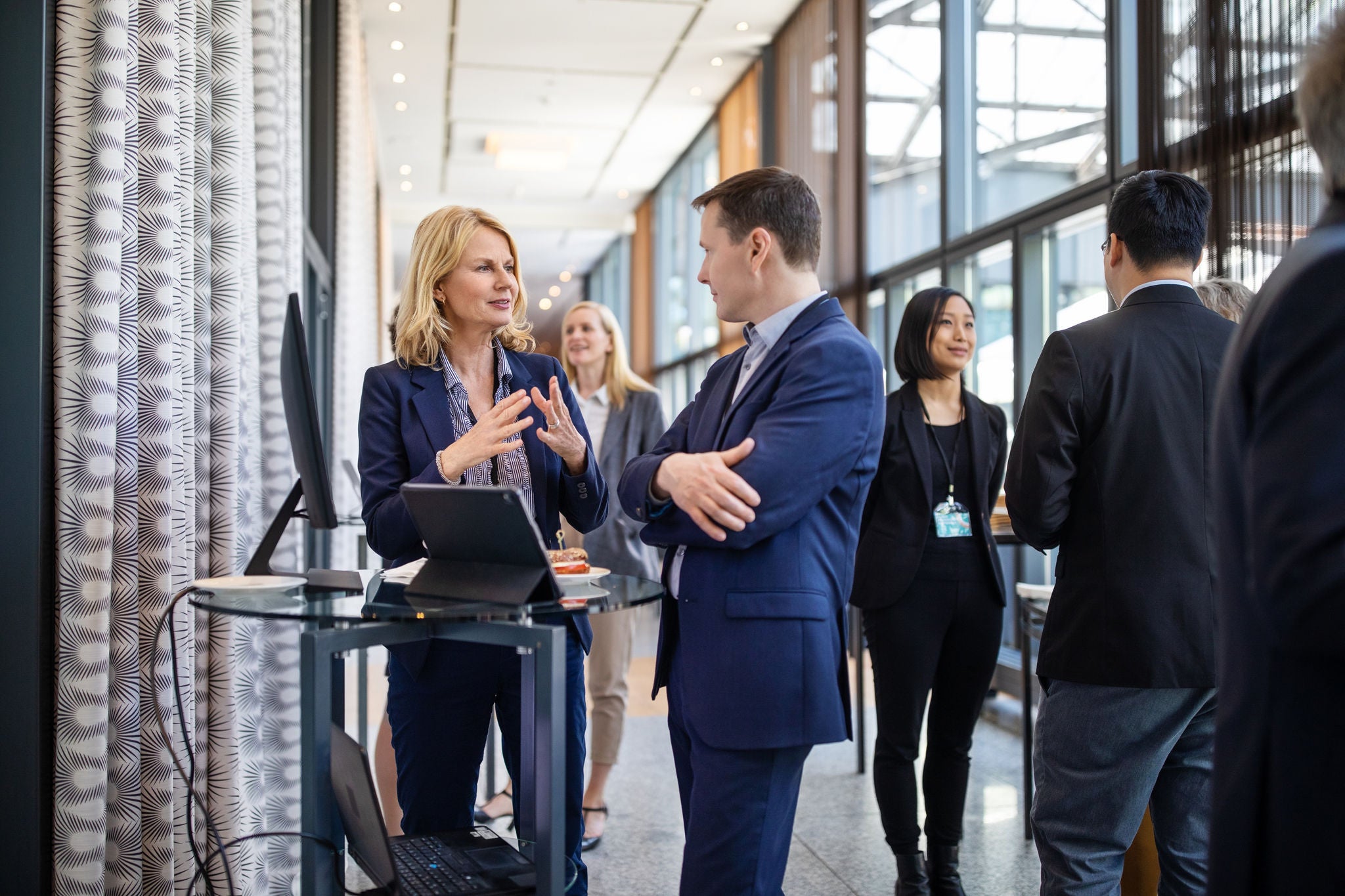 Businesswomen planning strategy with businessman in auditorium.