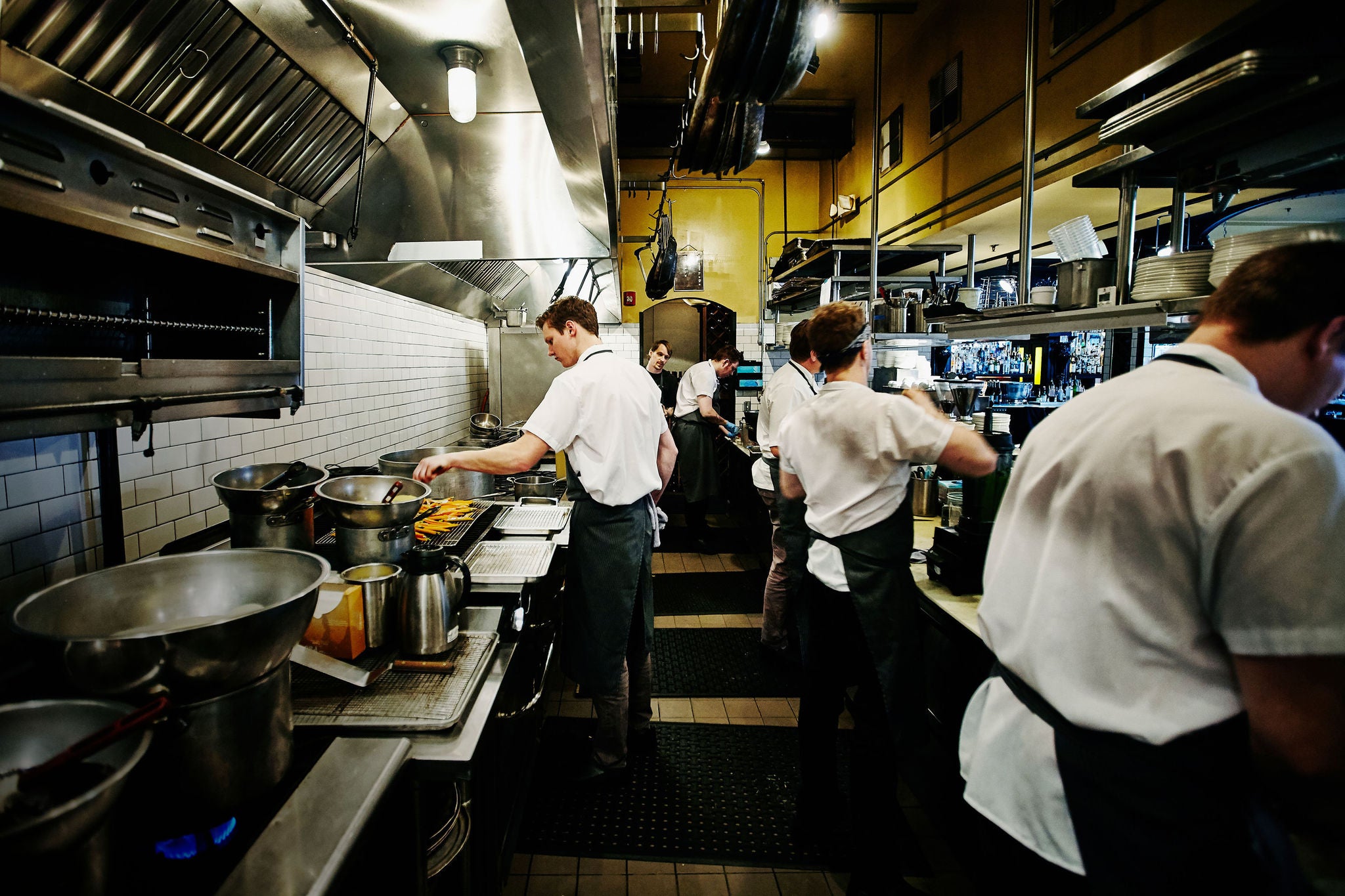 Chef and kitchen staff preparing dinner in restaurant kitchen