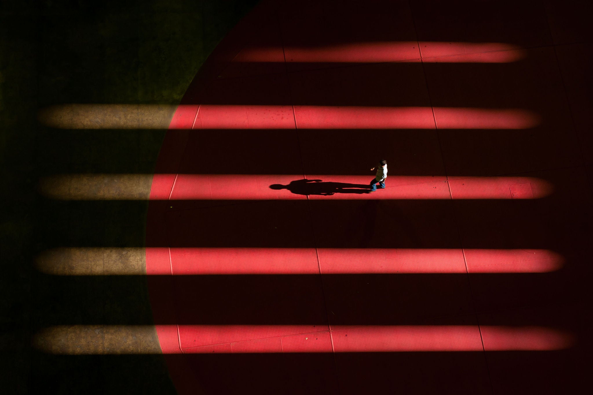 A man walking on the cover of a generator at a hydroelectric power plant