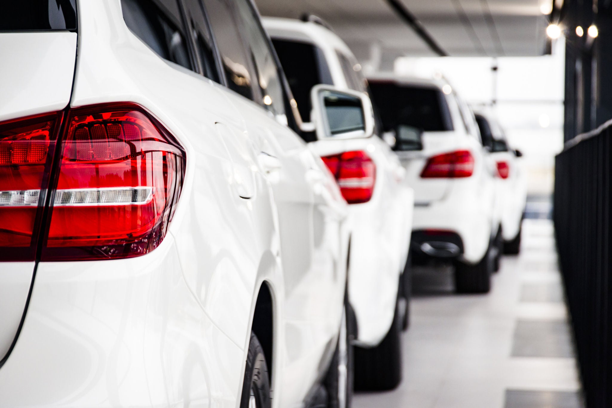 A row of new cars parked at a car dealer shop