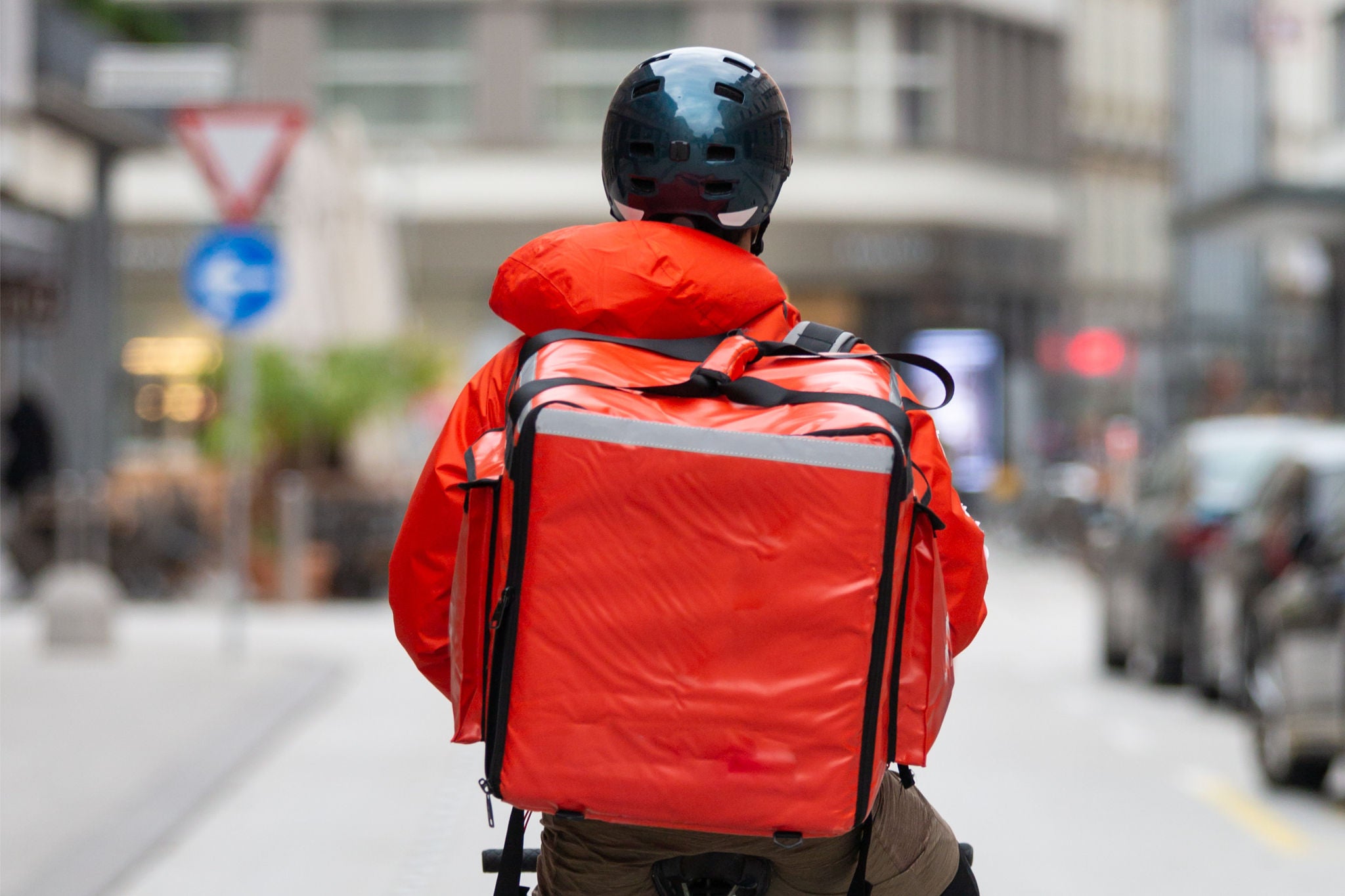 Kurier auf dem Fahrrad liefert Lebensmittel in der Stadt aus