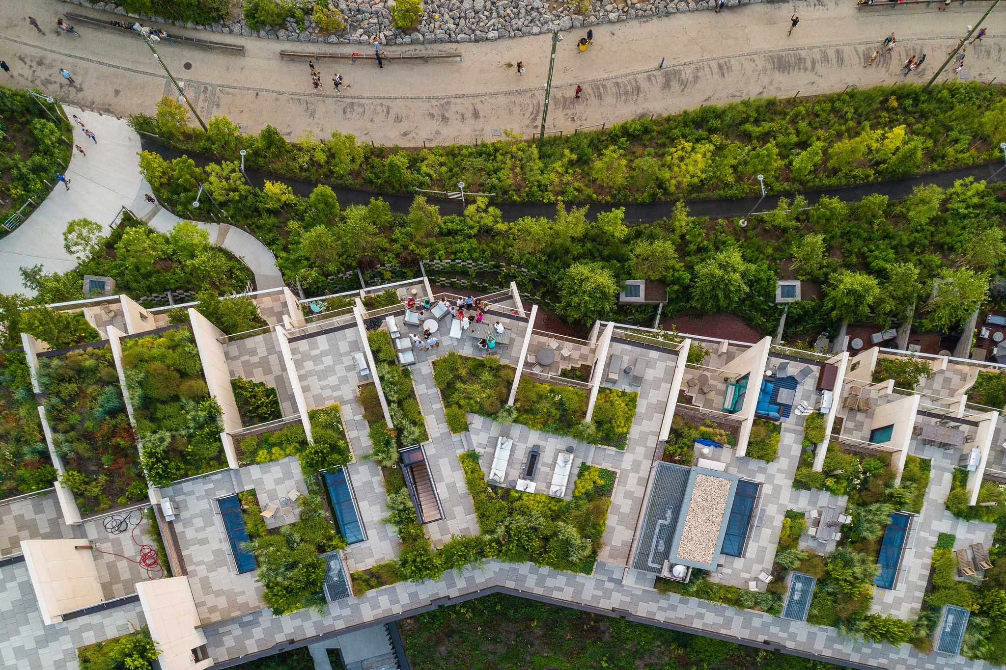 The top directly above view to the modern rooftops with gardens in Brooklyn Heights, on the waterfront nearby Esplanade and Brooklyn Bridge Park at the hot summer evening