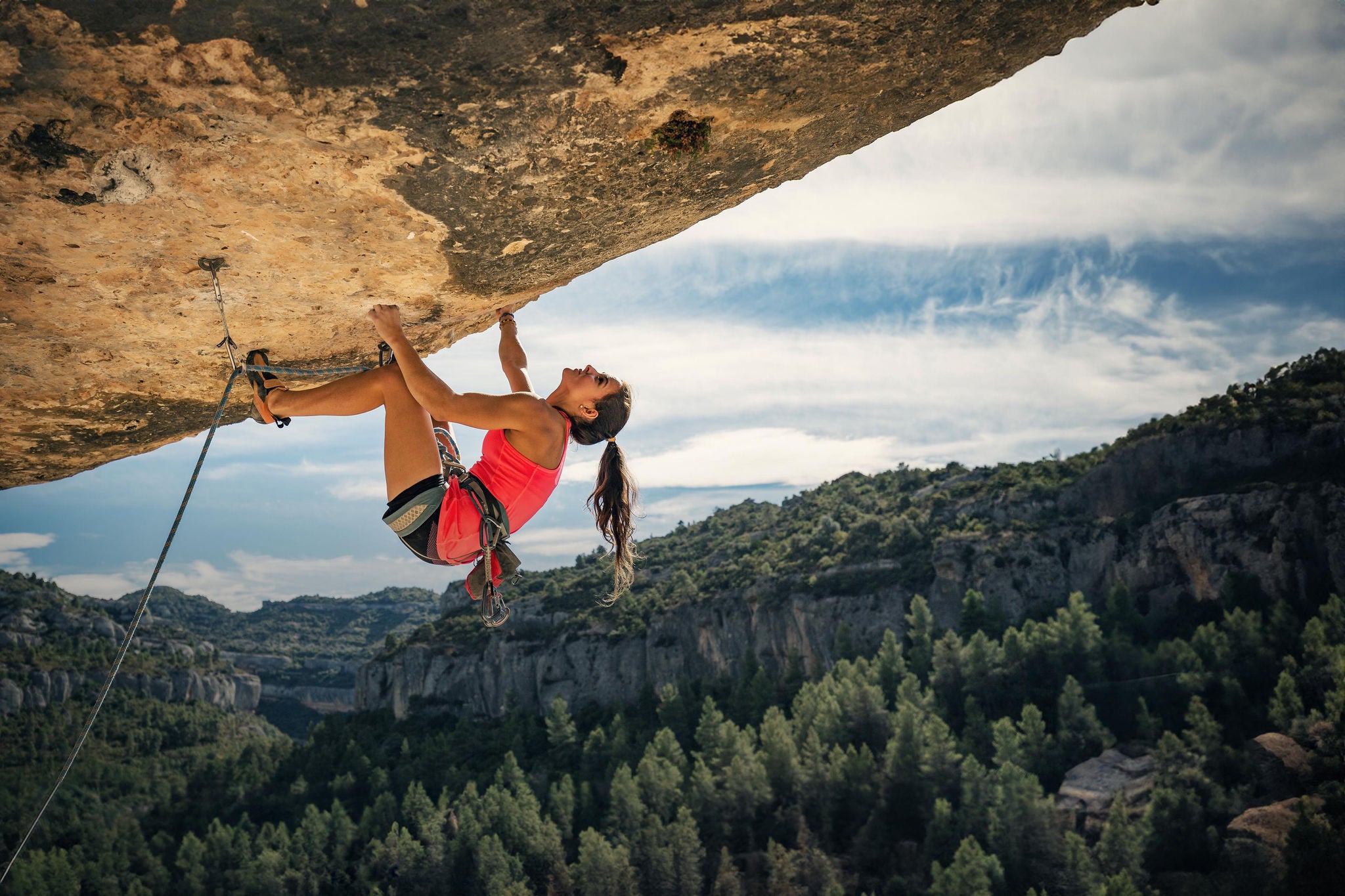 Young woman rock climbing in Margalef Catalonia Spain