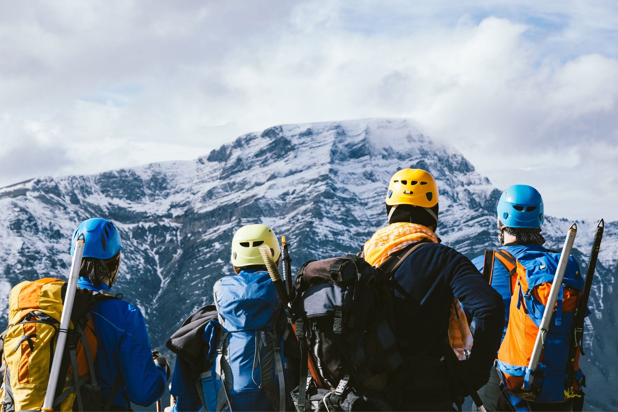 Mountaineers overlooking a snow-covered mountain