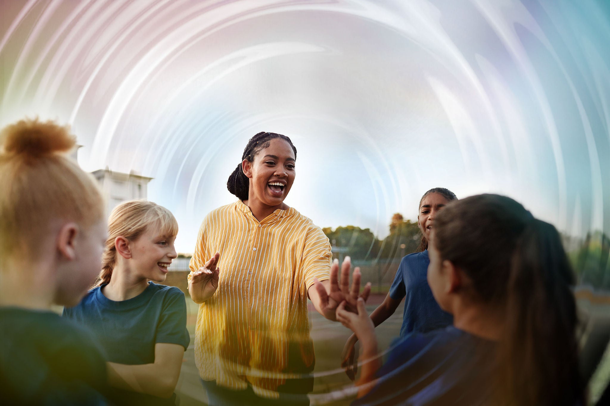 coach celebrating with students in schoolyard ripples overlay