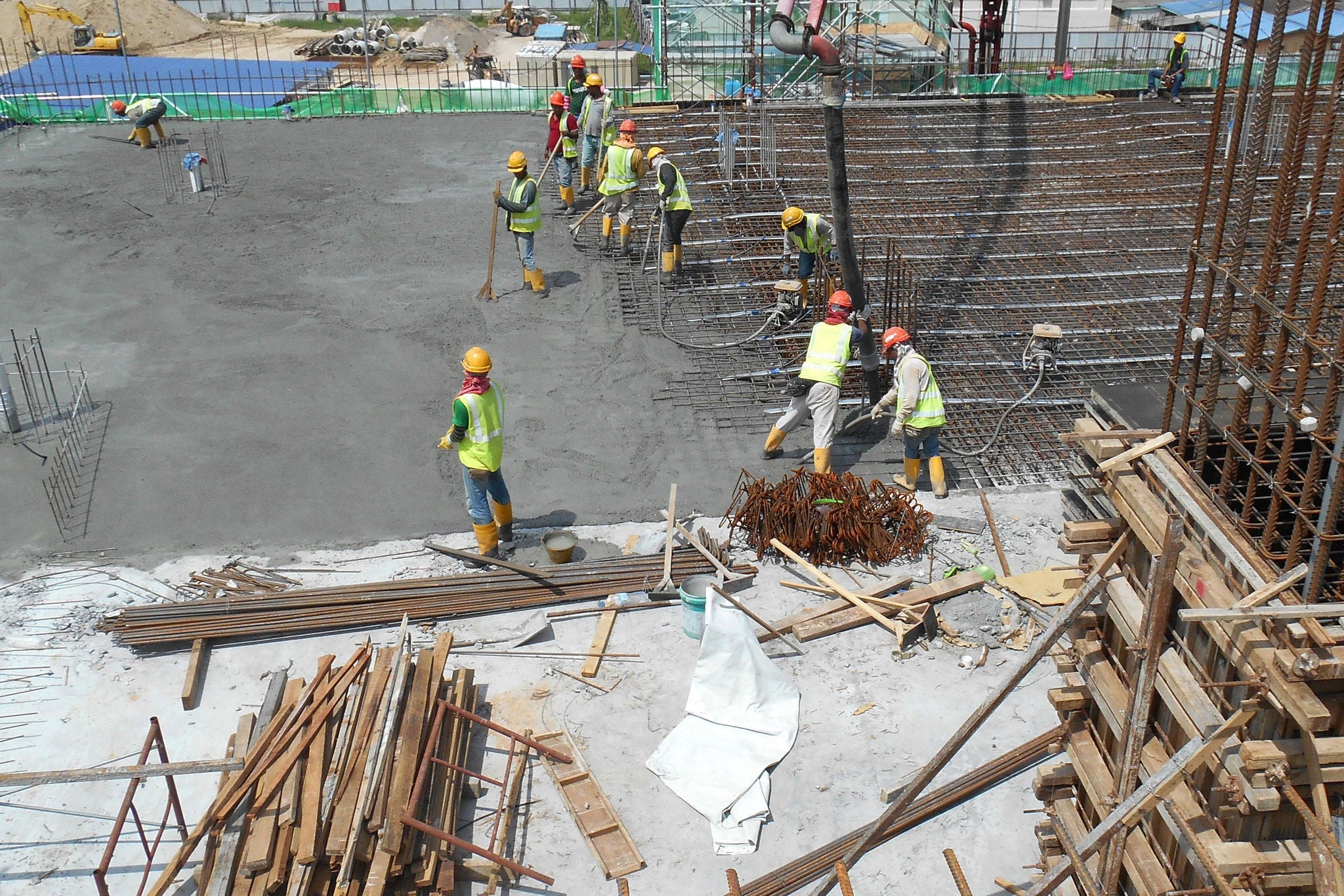 Construction team pouring concrete