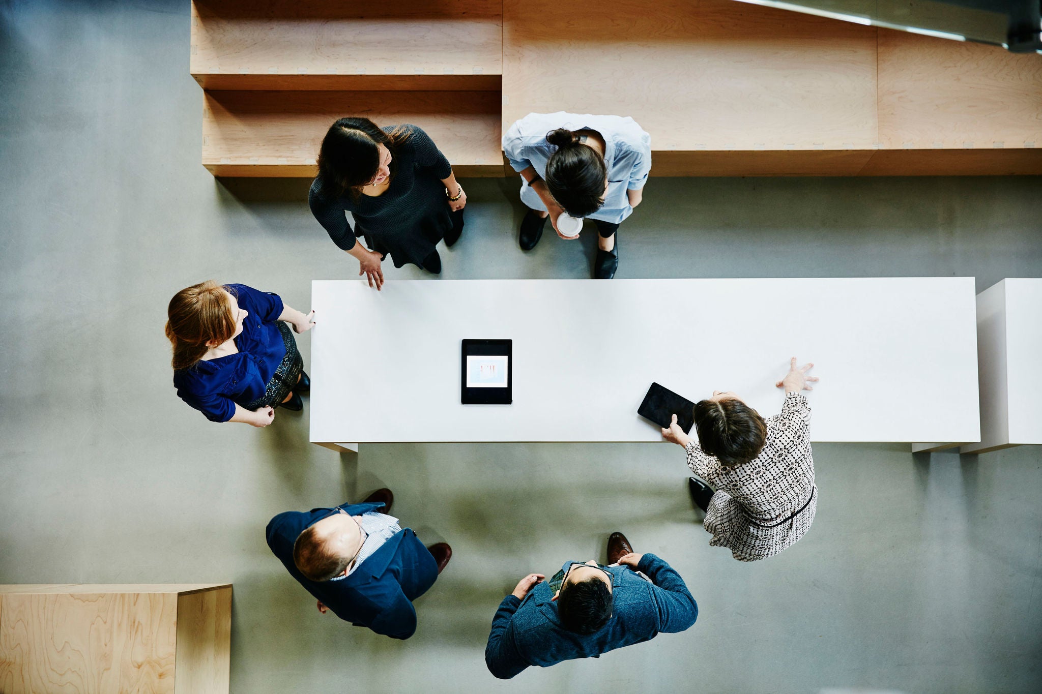 Overhead view of businesswoman leading team project meeting