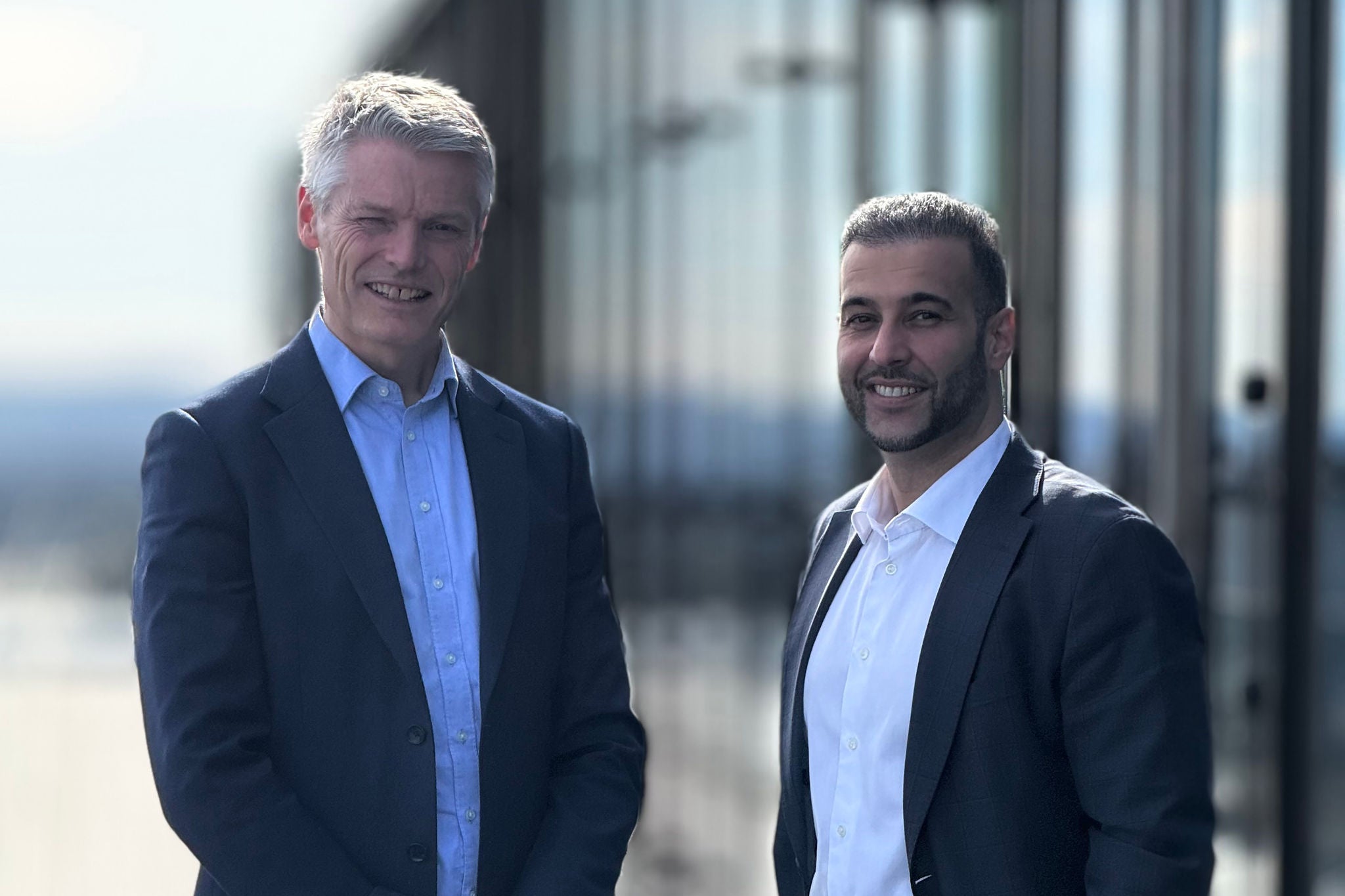 Bilde av Kjetil Rimstad og Arbab Dar utenfor hovedkontoret til EY på Stortorvet.