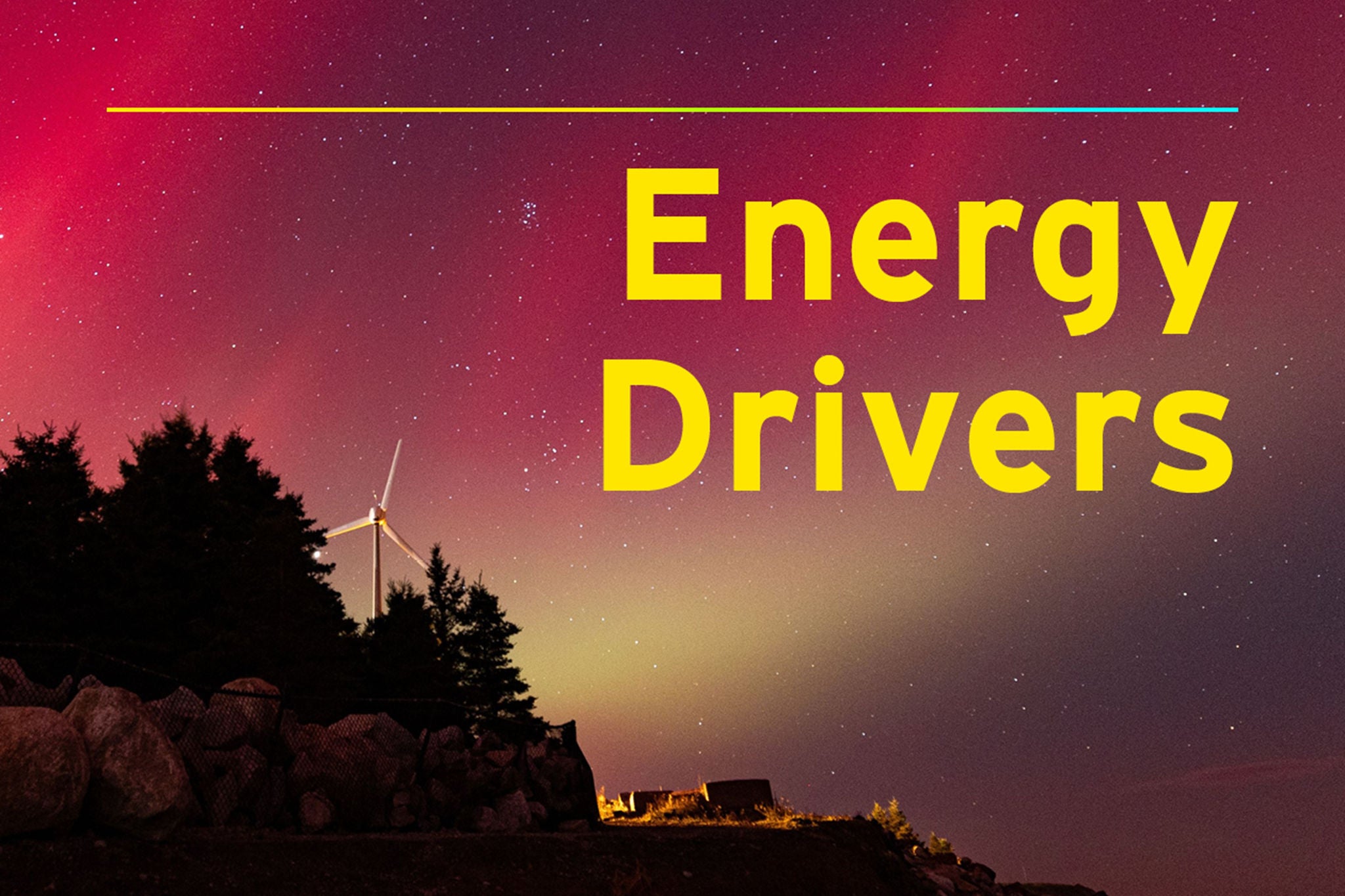 Red and green aurora over a wind turbine at night