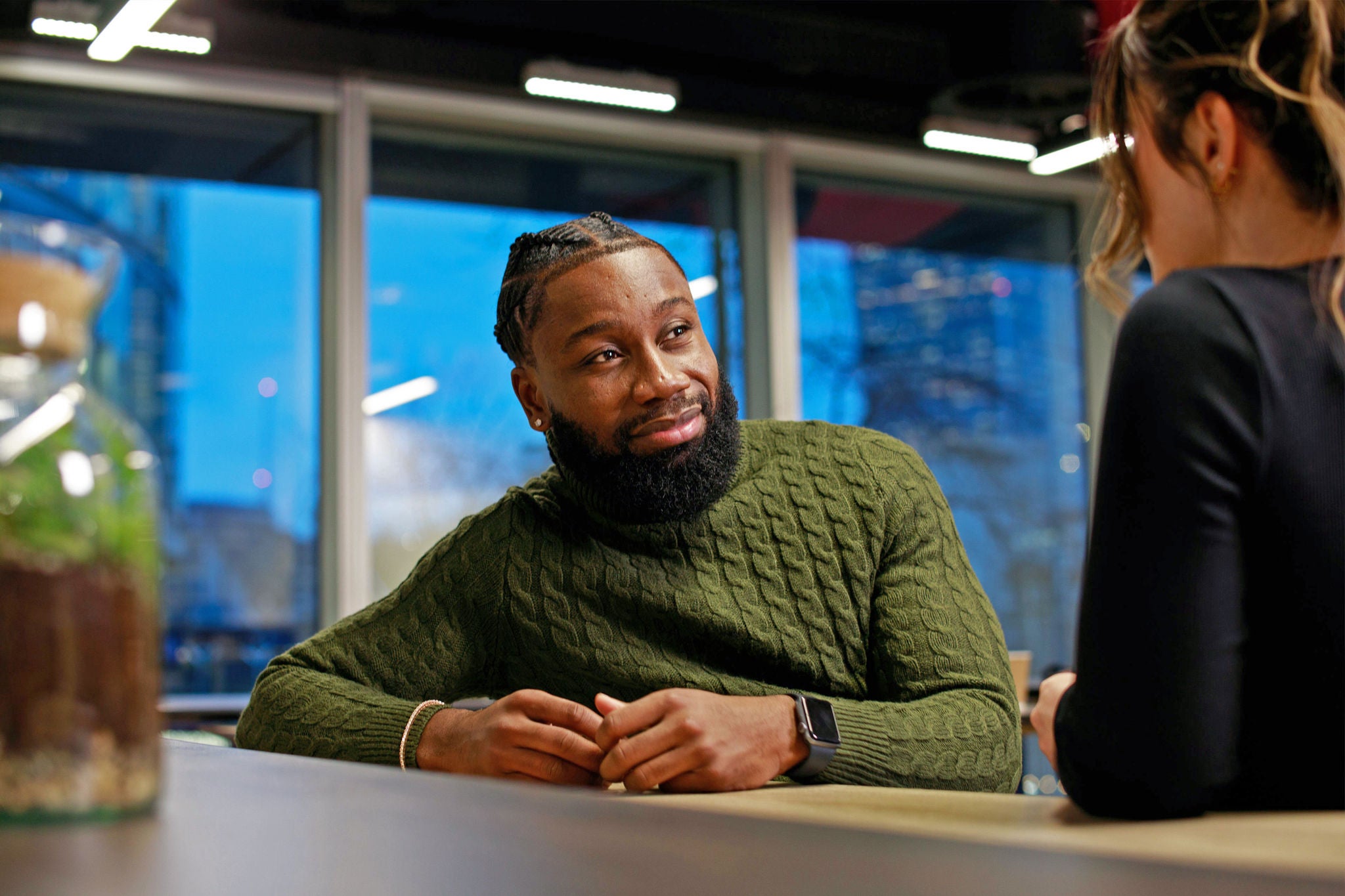 Two people standing at a high table