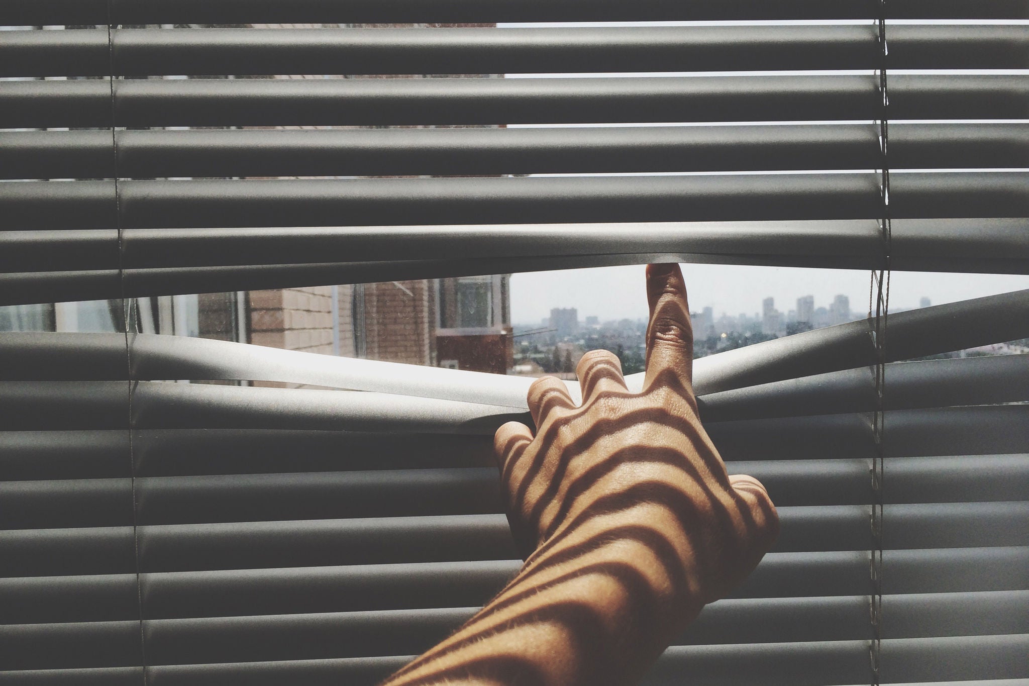 Close-Up Of Person Looking Through The Window