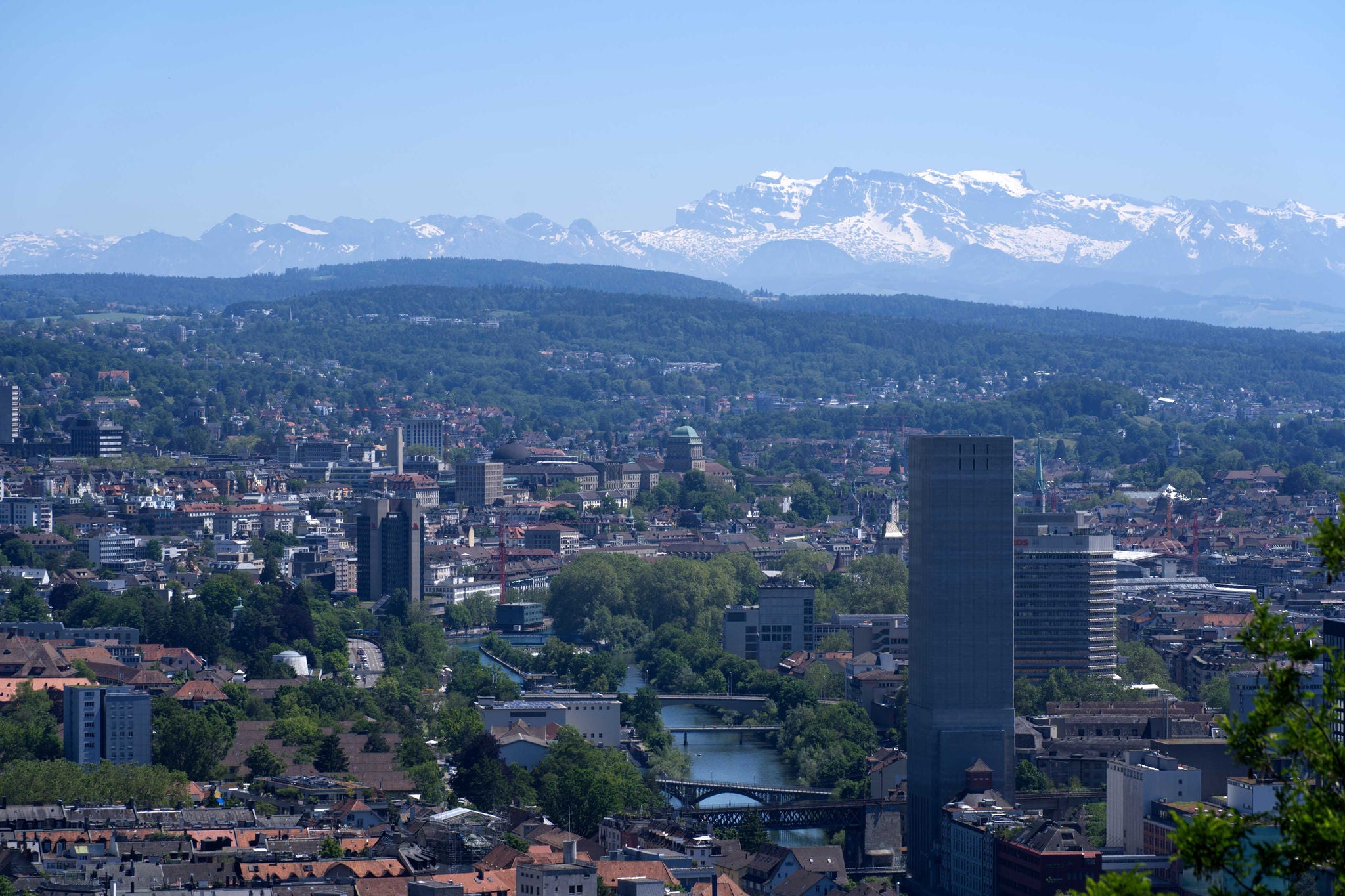Panorama view over the City of Zurich with river Limmat and Swiss alps in the background at a beautiful summer day. Photo taken June 14th, 2021, Zurich, Switzerland.