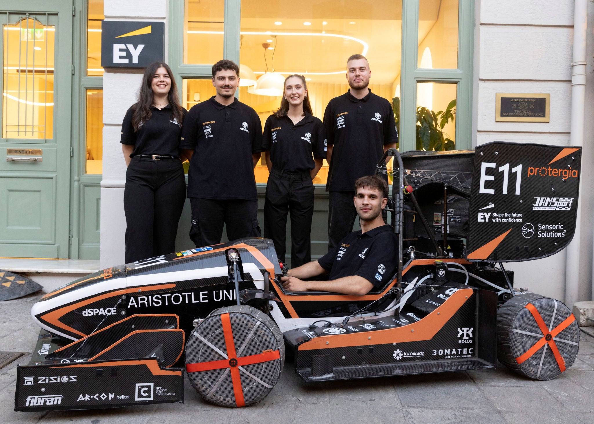 aristutrle team driving an electric racing car outside ey thessaloniki