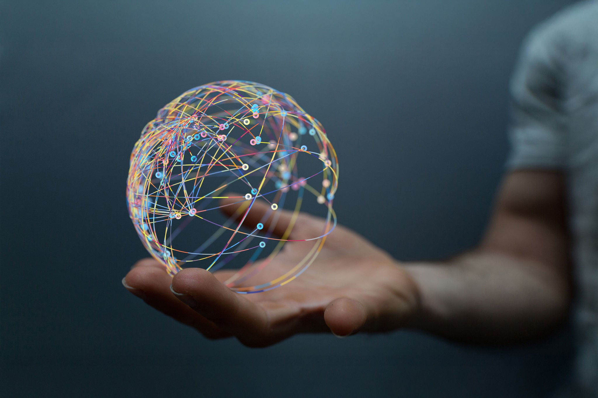 A hand holding a 3d Global Network model