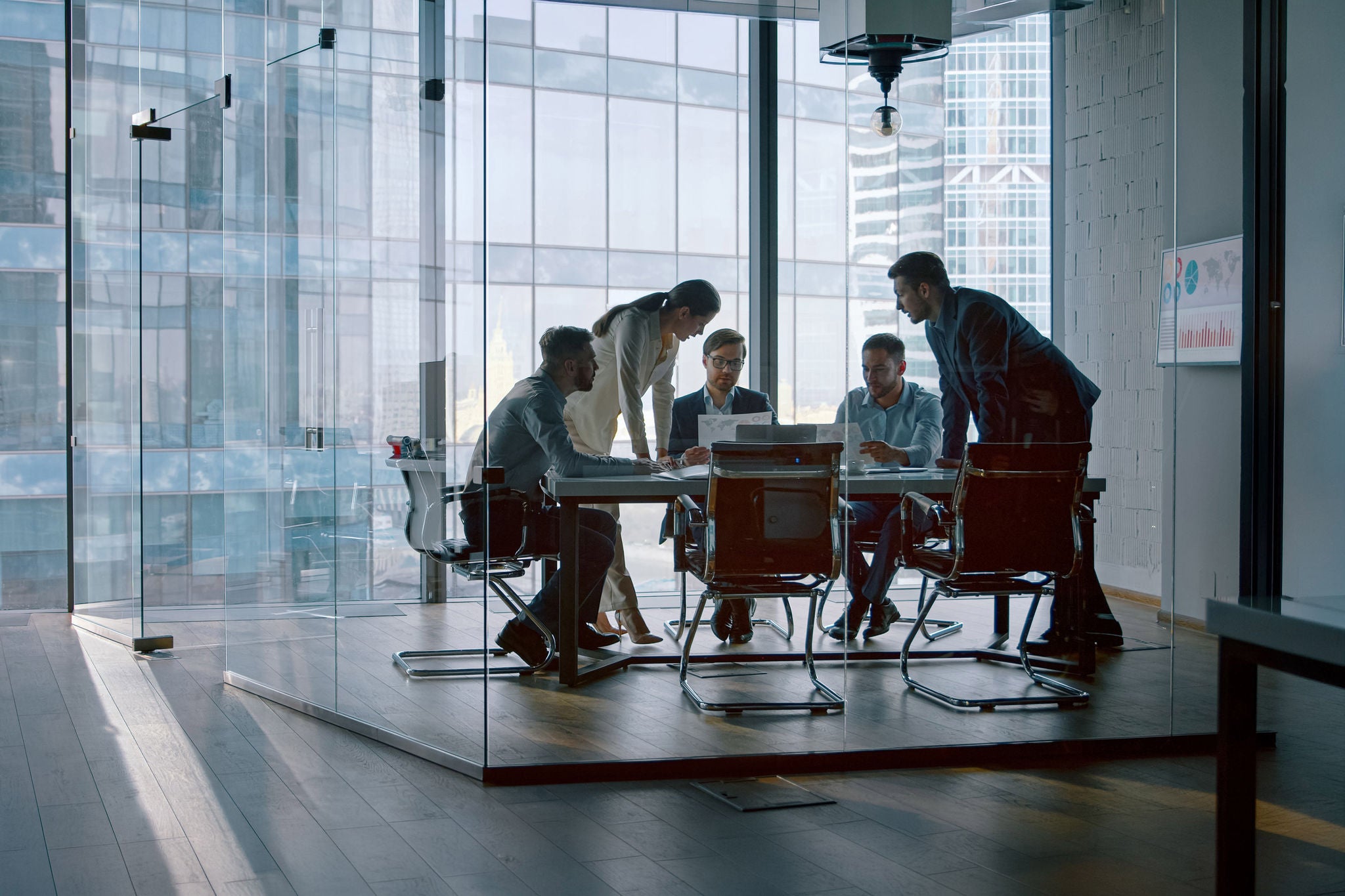 Young businesswoman telling colleagues her development vision at a meeting in office