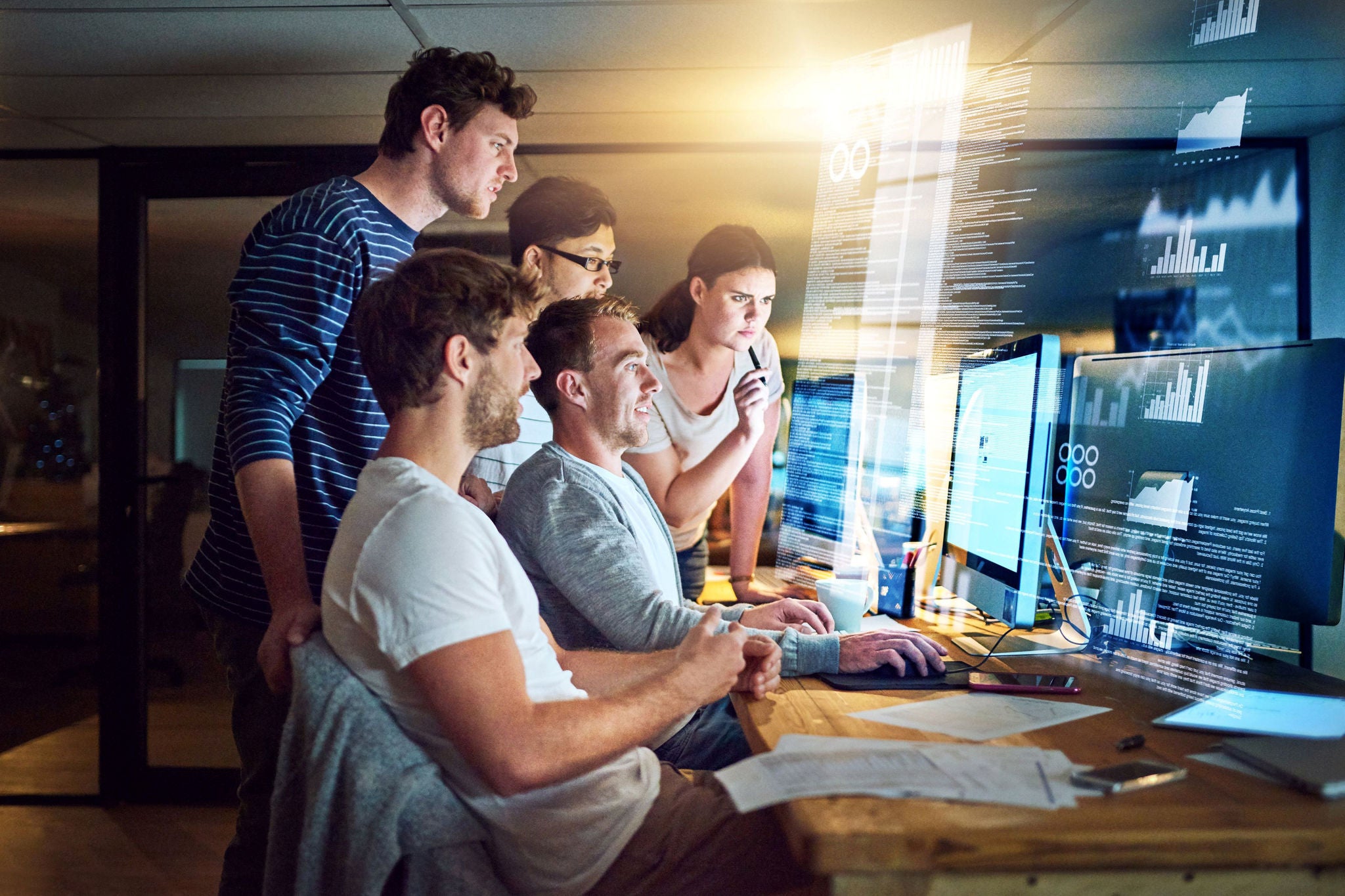 Landscape photograph of a team of computer programmers working to debug software.