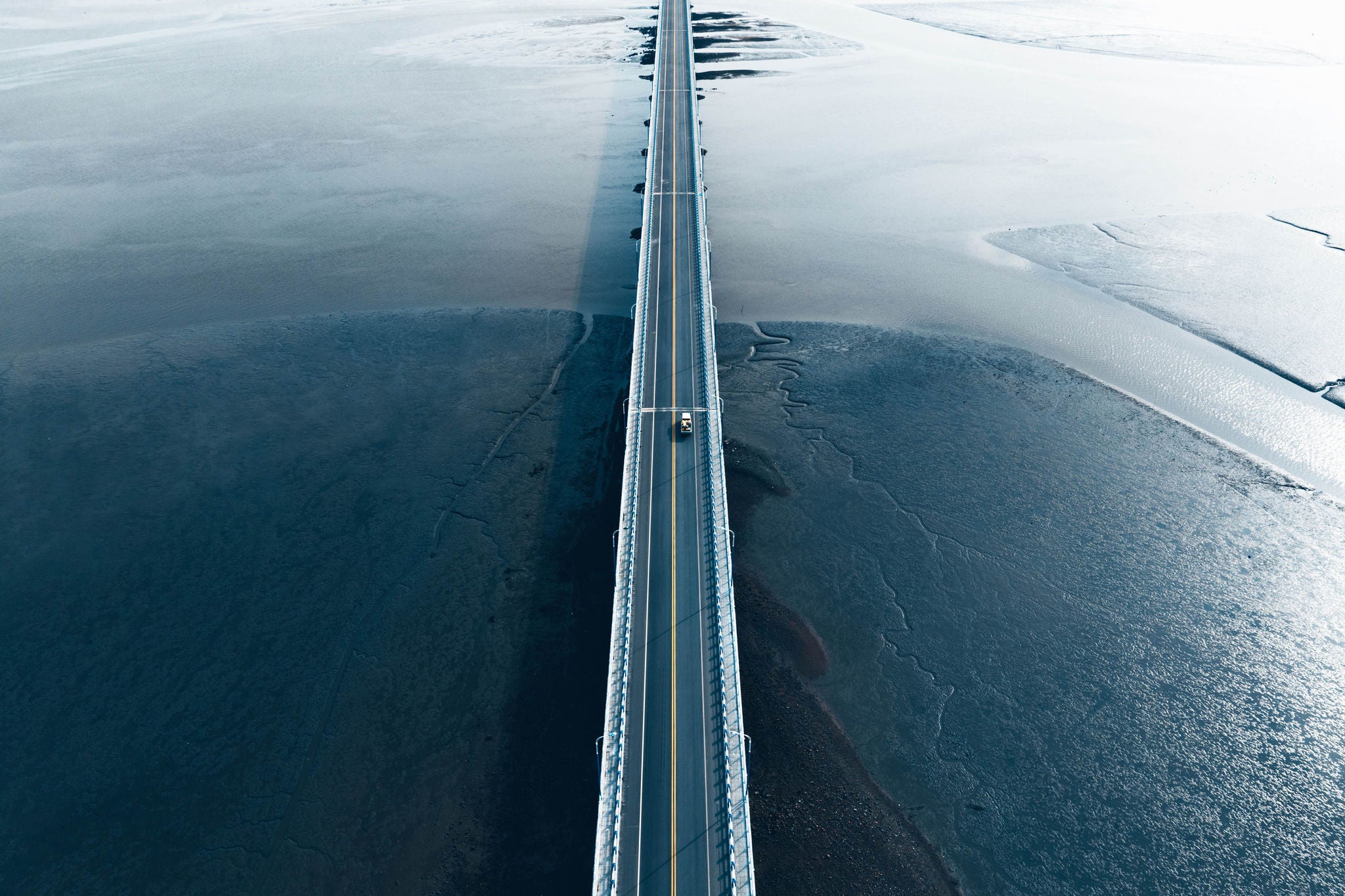 Aerial view of long bridge over marsh