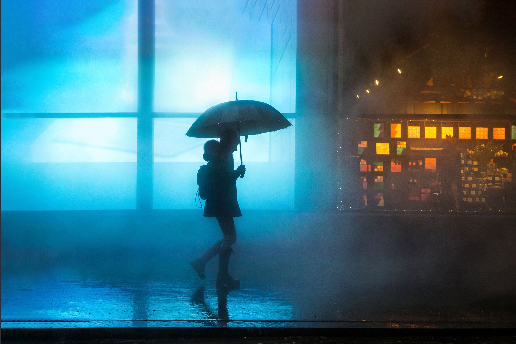 Foggy downtown lower manhattan woman walking with-umbrella