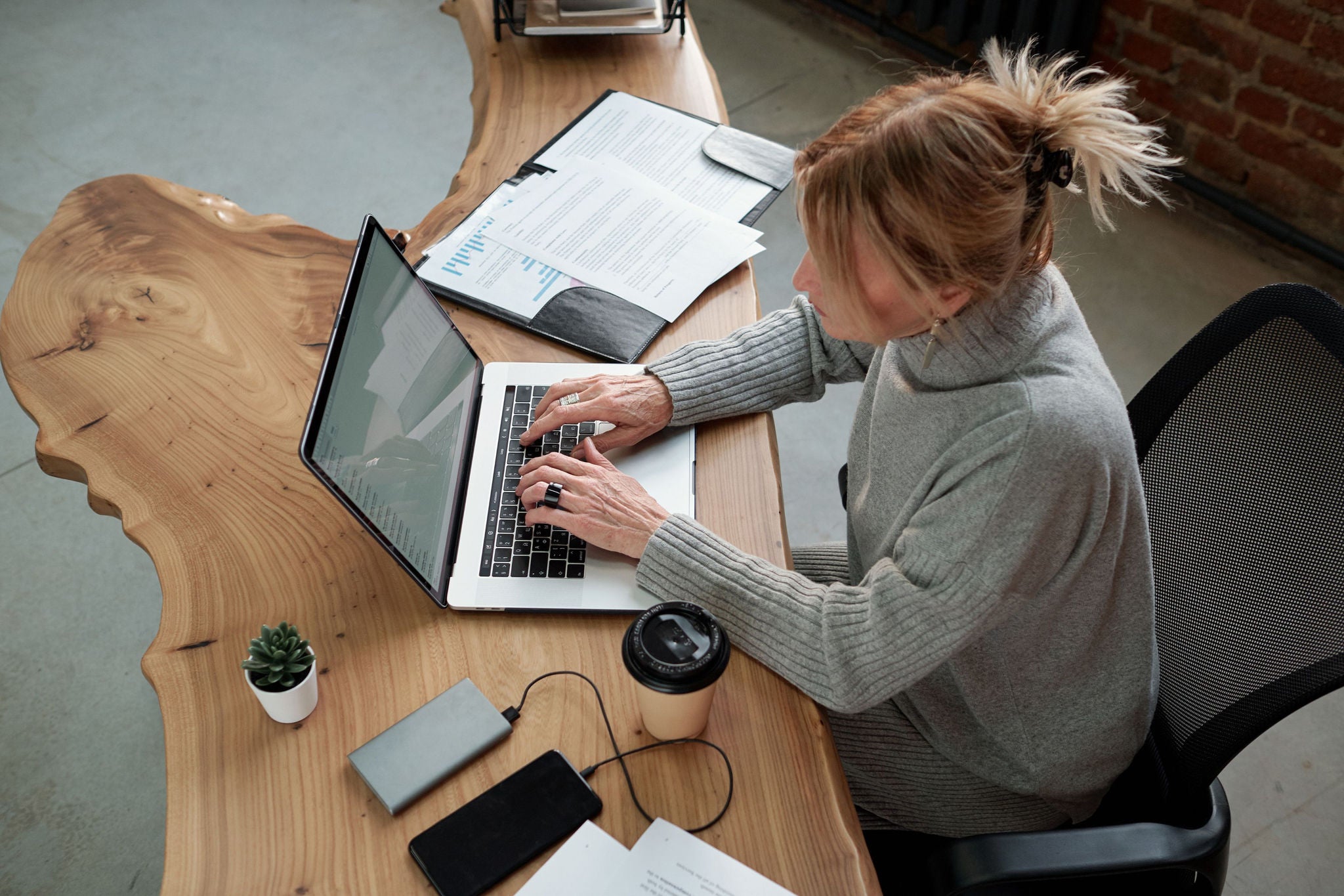 Woman working on the laptop reporting 